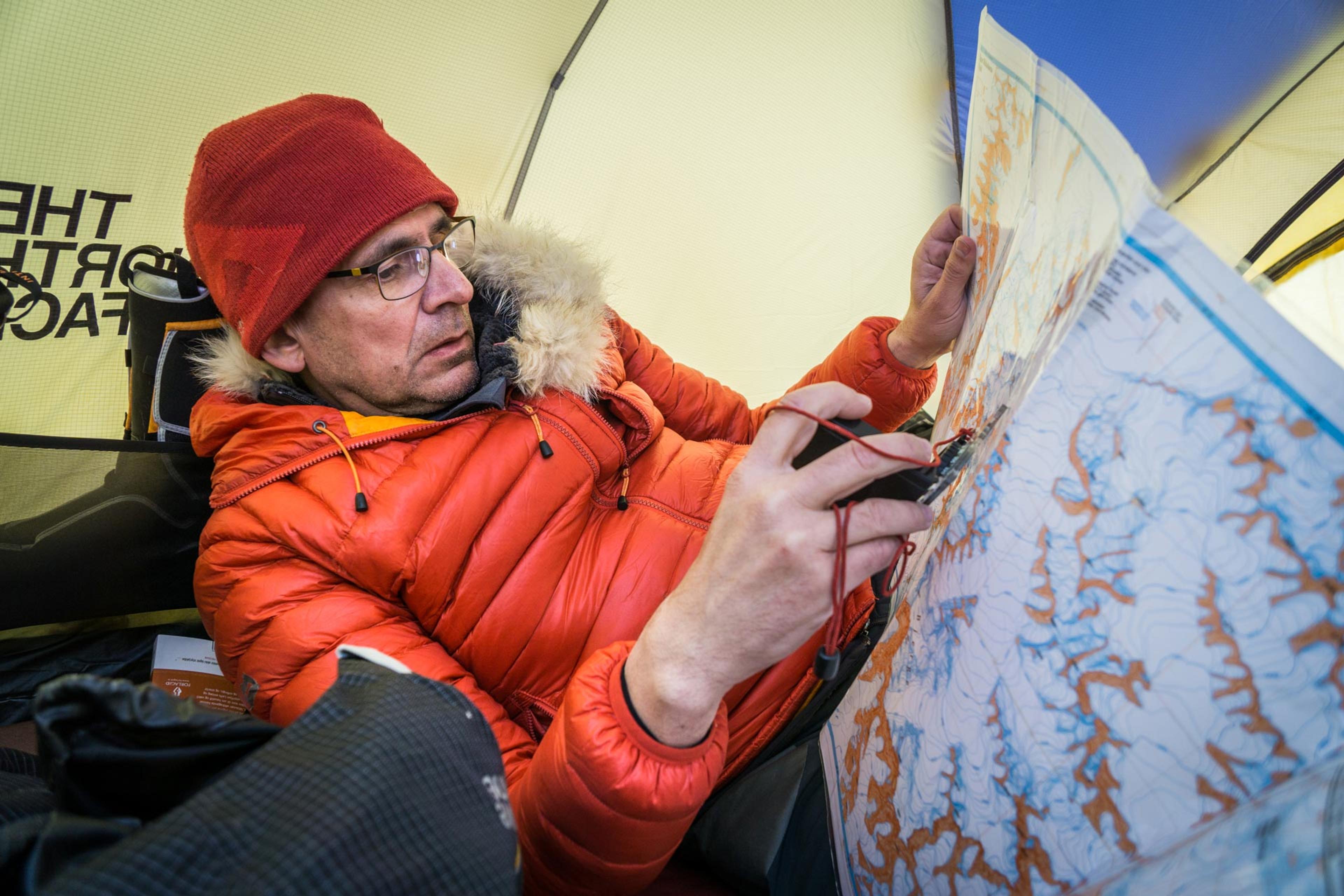 A guide looking at a map, planning next mission