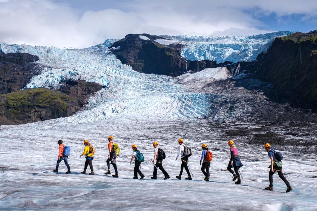 A group of hikers traversing the glacier in fantastic scenery
