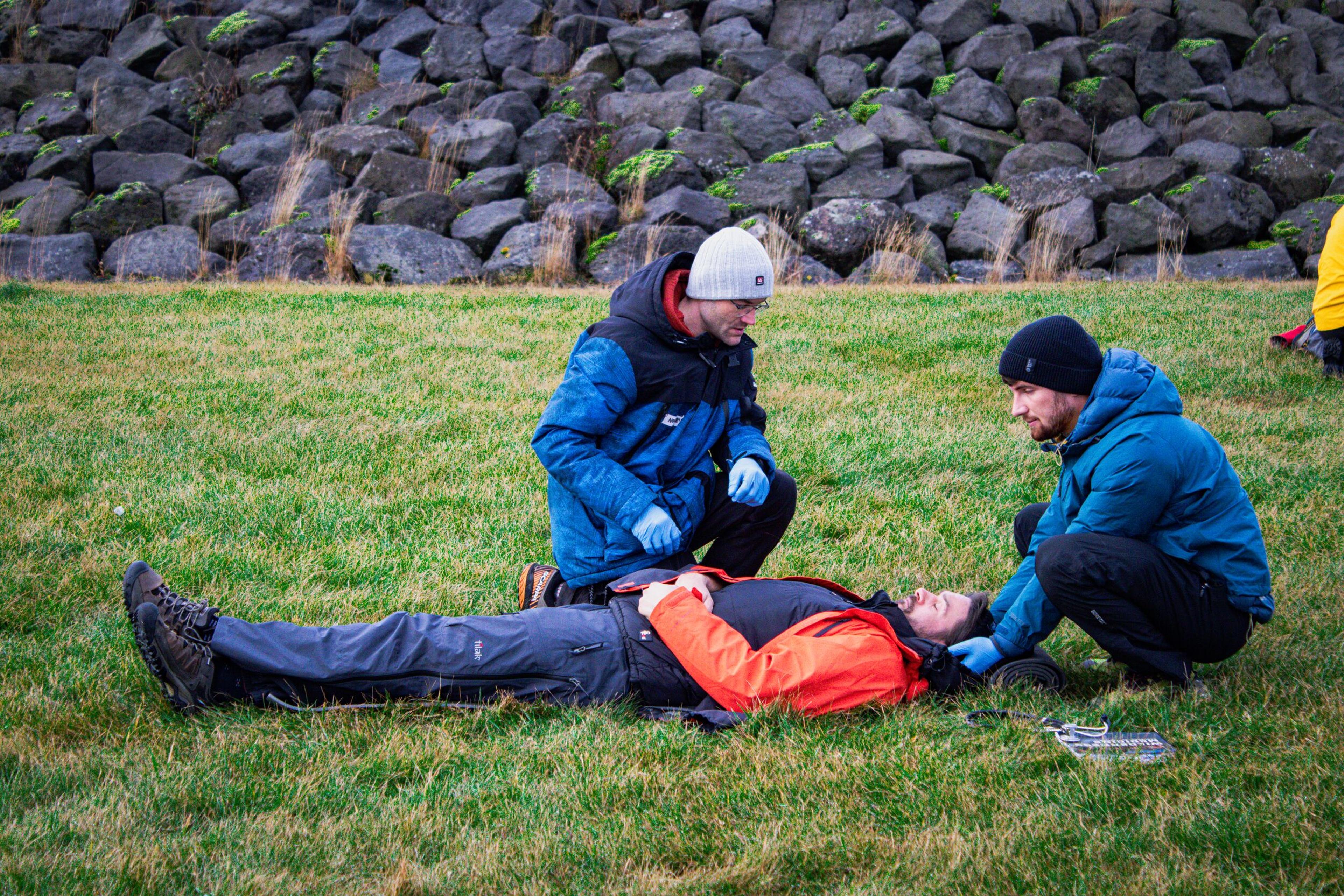 a group of individuals participating in a simulated rescue training.