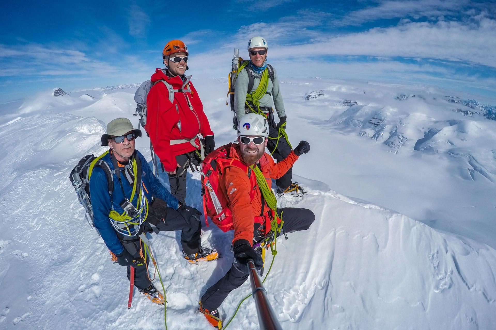 The expedition team standing on top of mt. Cone
