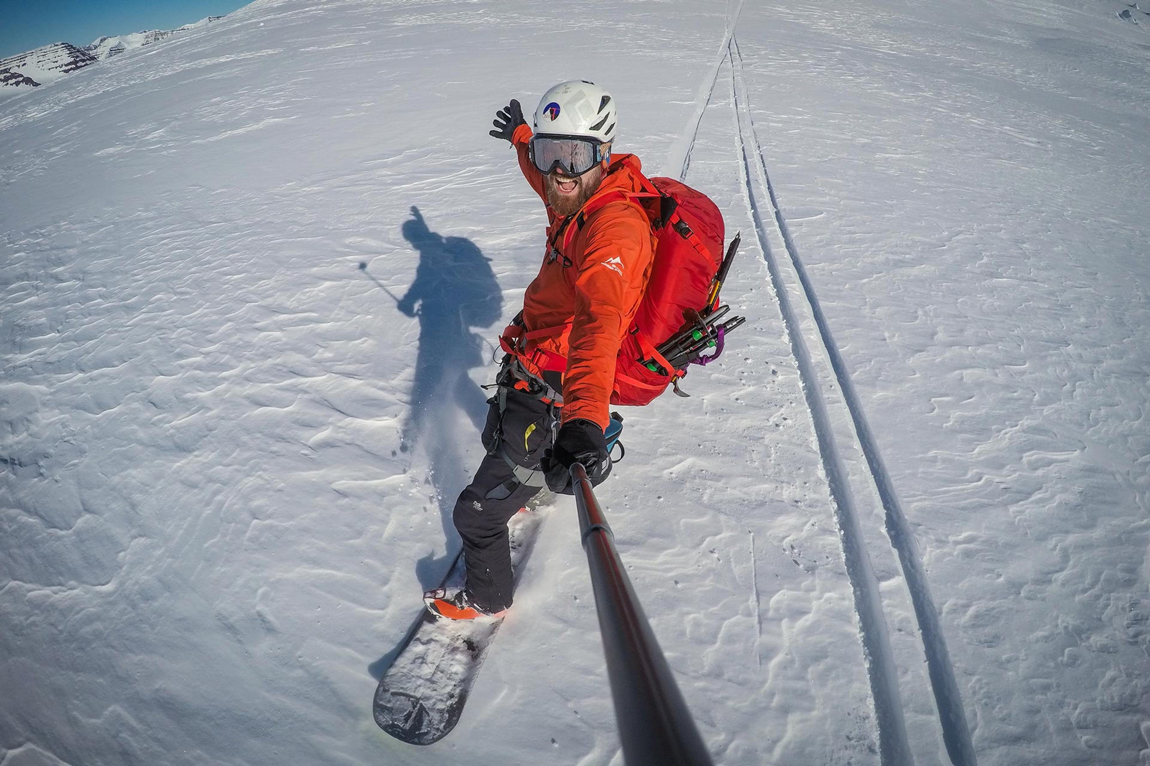 A man snowboarding down the mountain