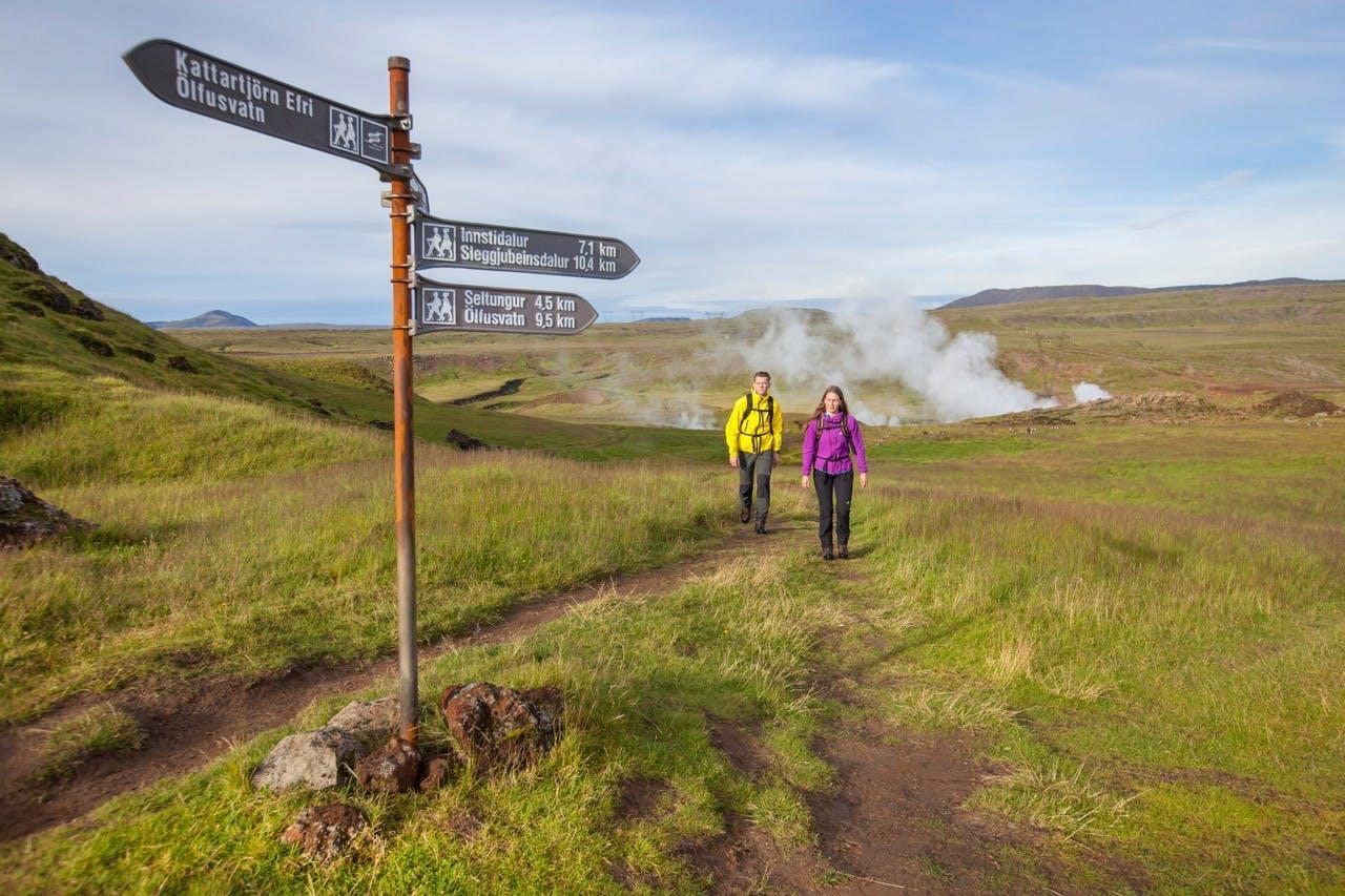 People hiking in Iceland to Reykjadalur hot thermal river