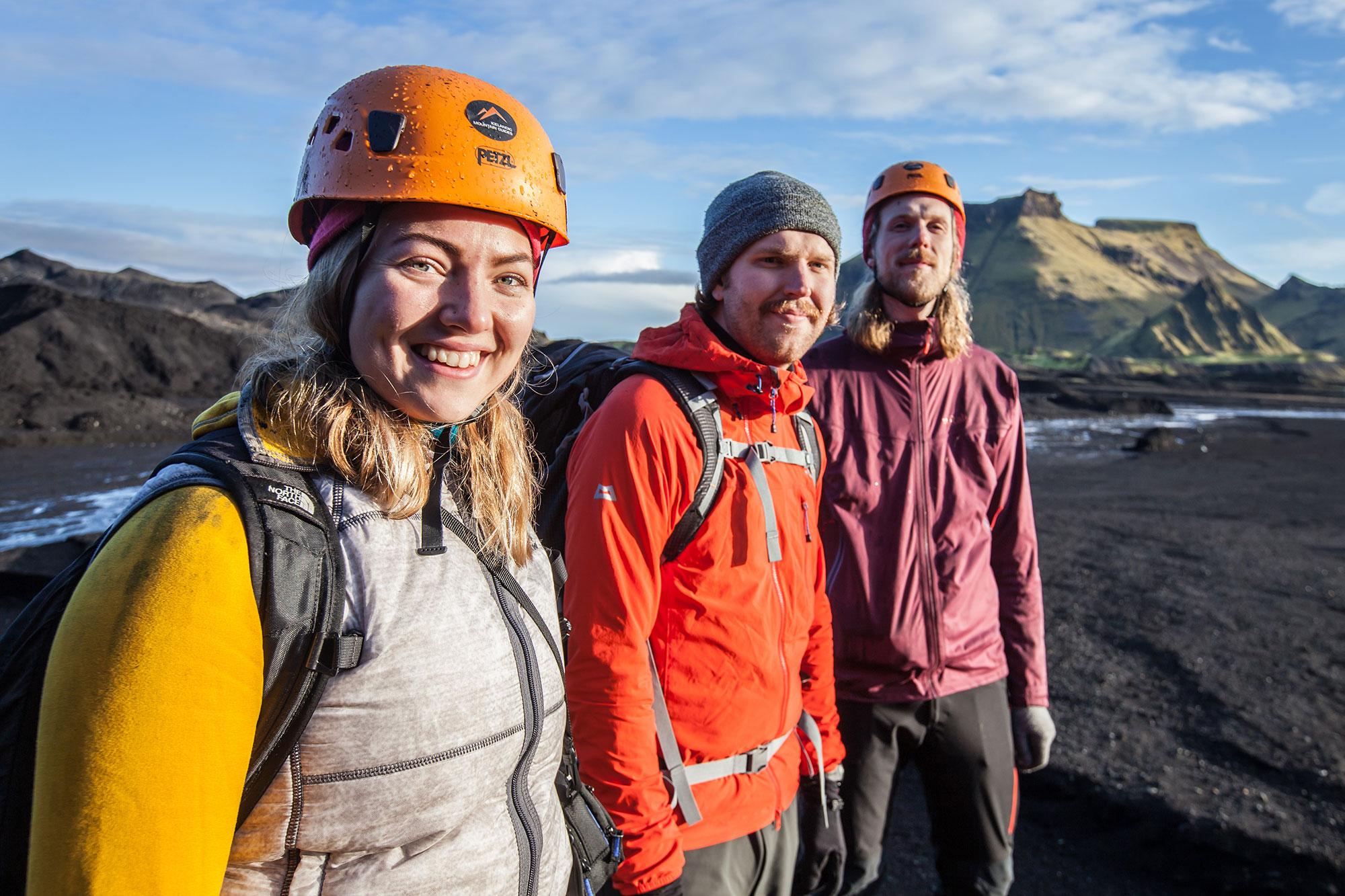 Happy tourists in Icelandic nature surrounded by black sand and mountains