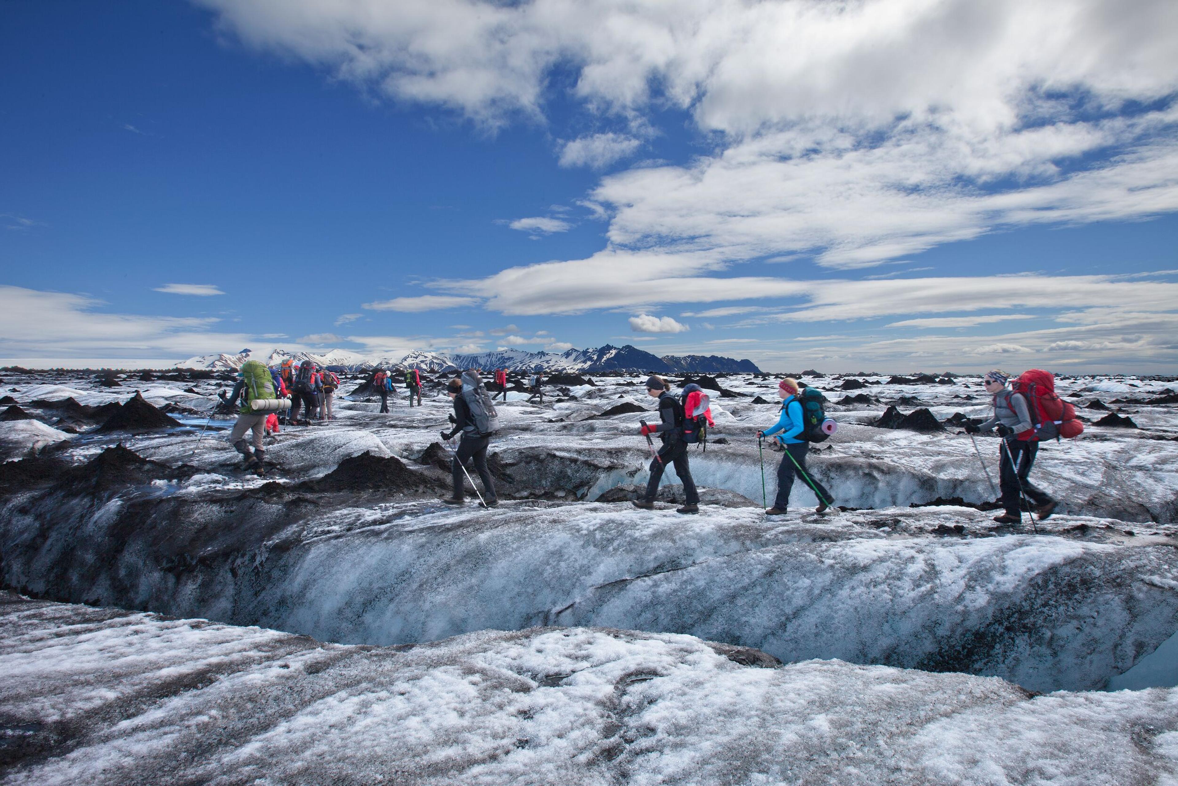 people walking on a glacier