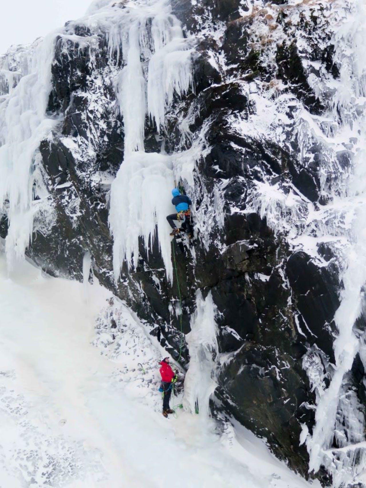 Man hiking up icy mountain