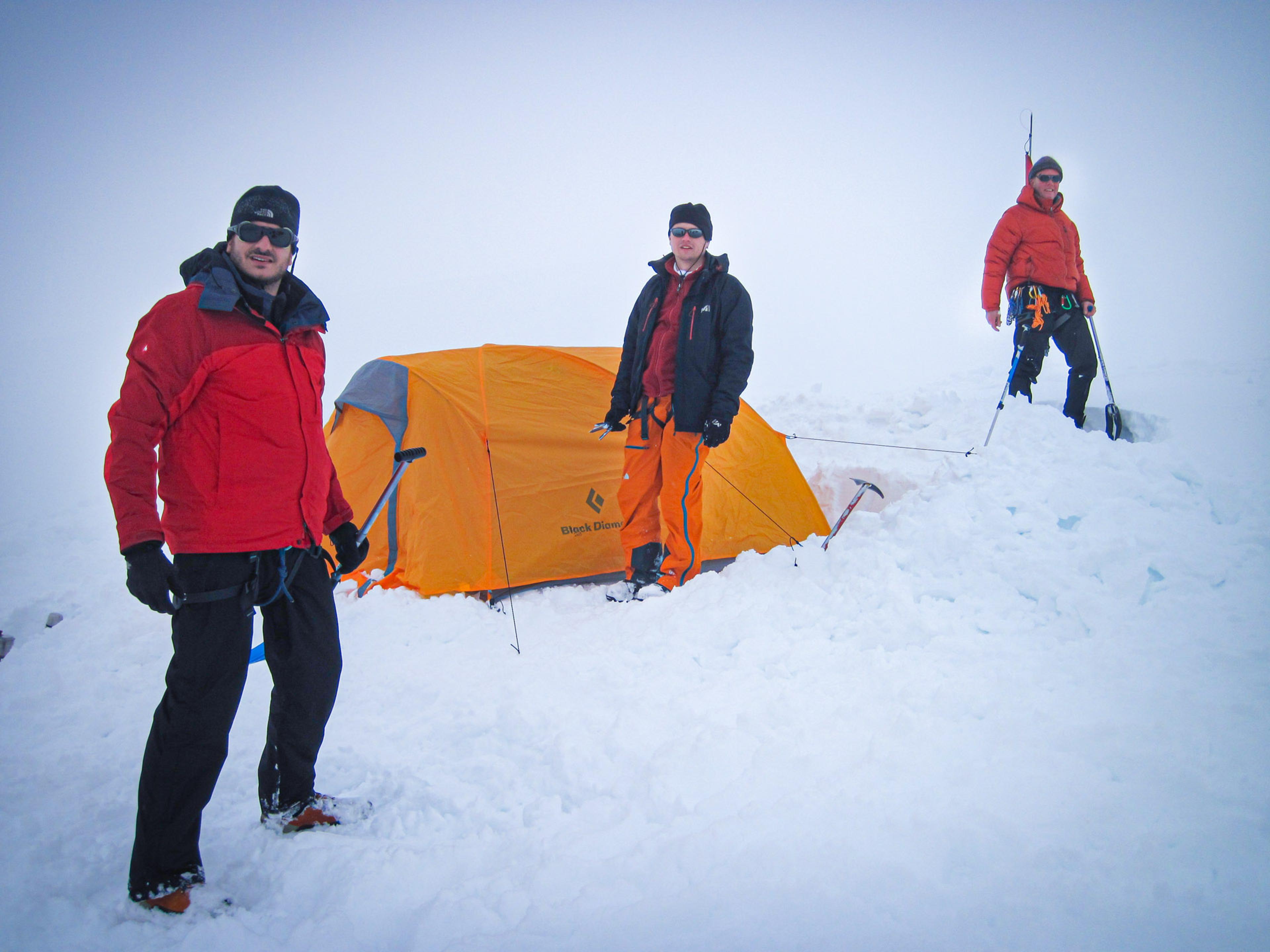 people tenting on a snowy mountain