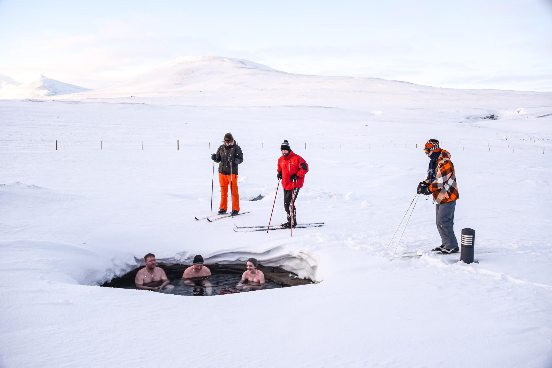Skiers and hot spring bathers posing together for a picture