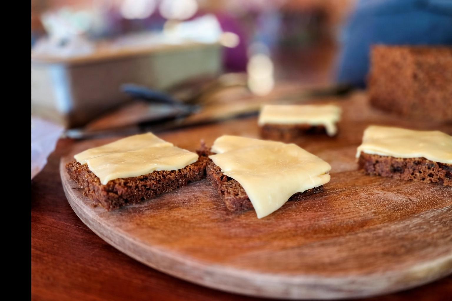 rye bread with butter on top on a wooden plate