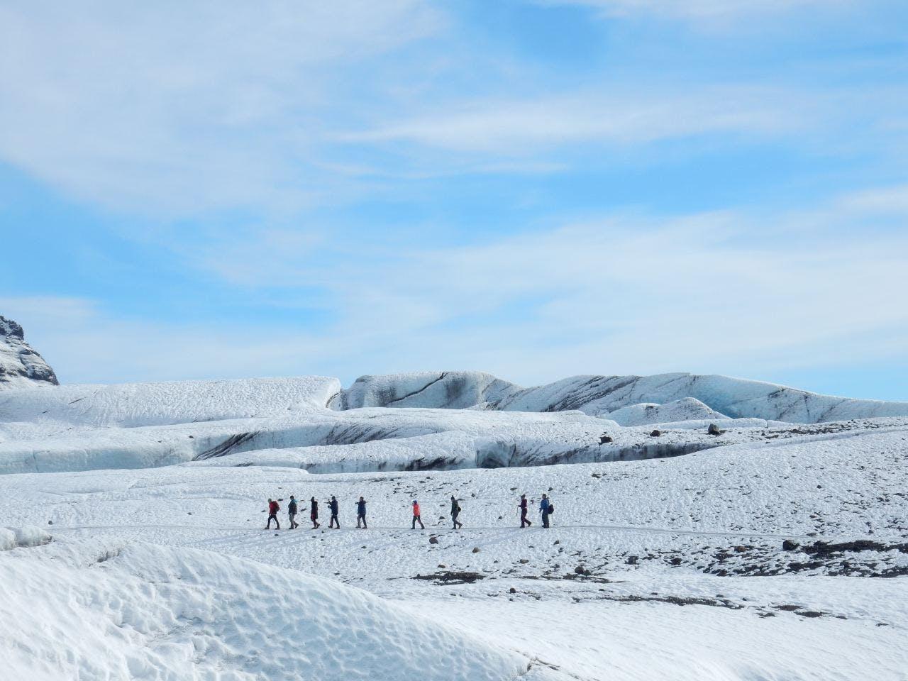 people walking through a snowy paradise nature in Iceland