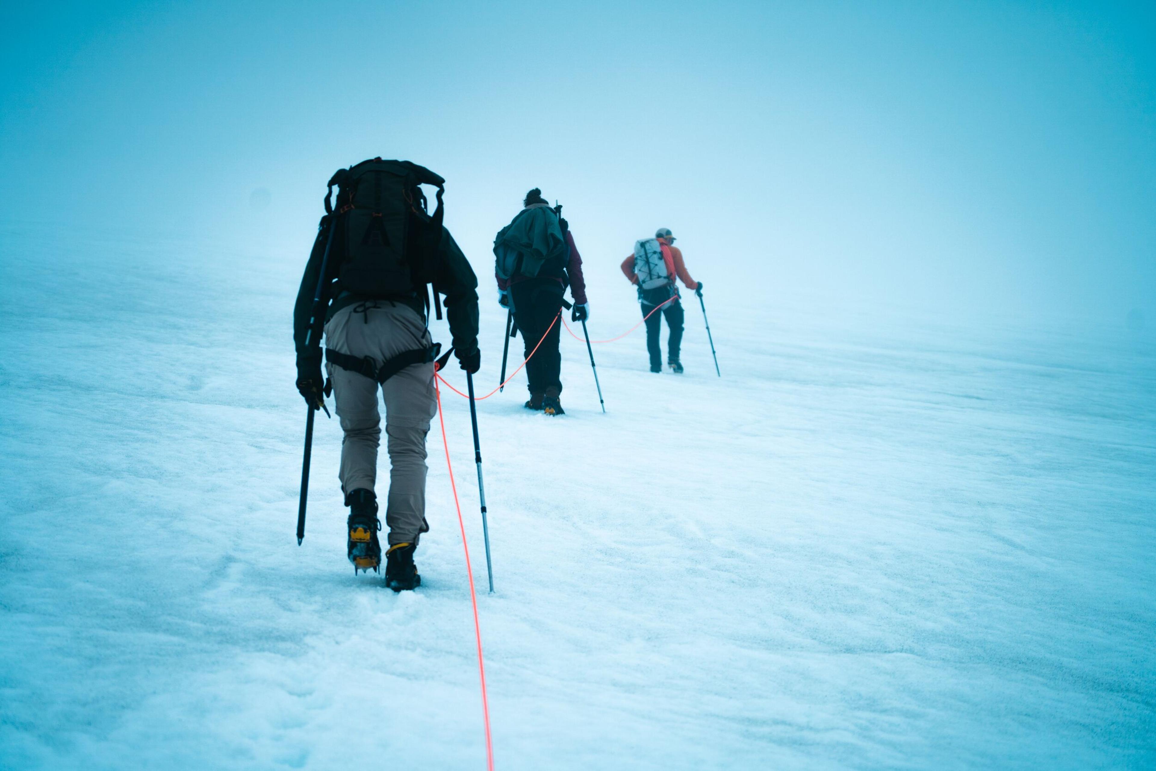 Three hikers in a line on their way to summit Eyjafjallajökull