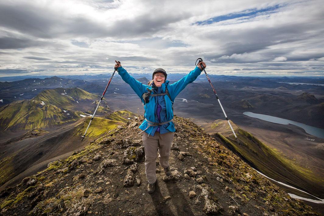 A happy hiker posing on the summit