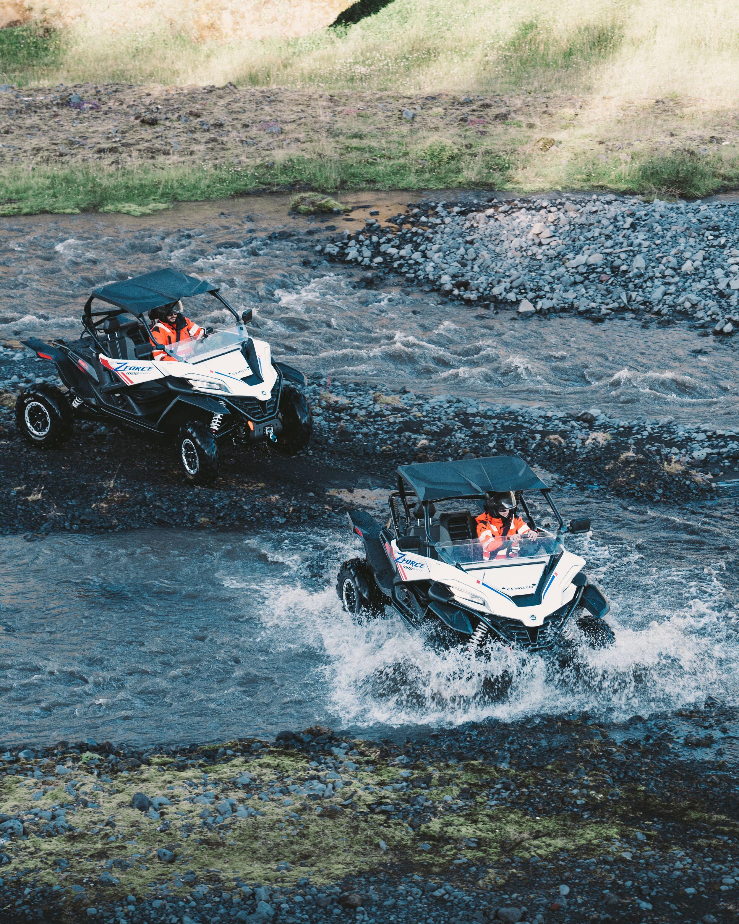 two buggy´s driving over a river