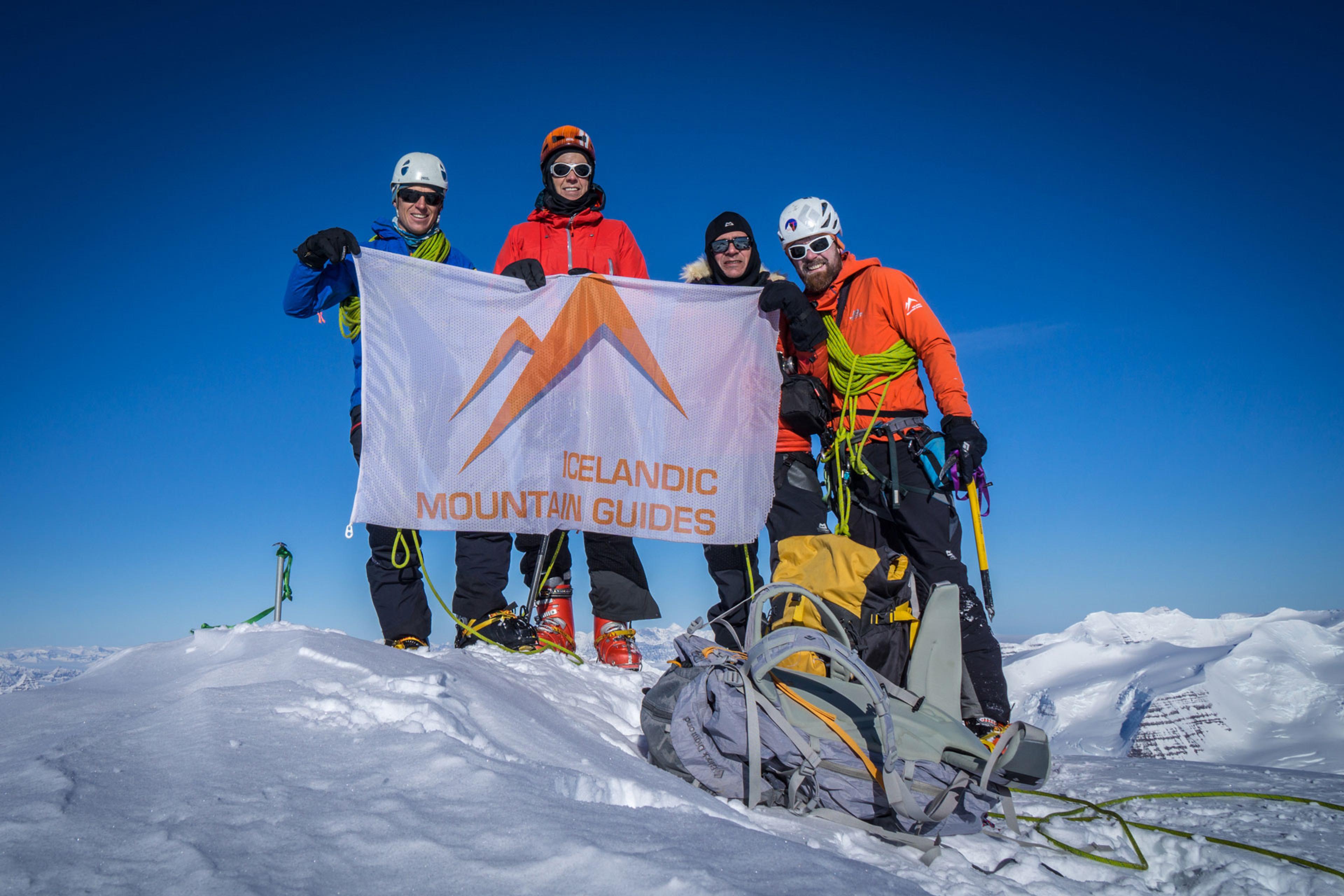 The team standing on top of the highest peak in the artic