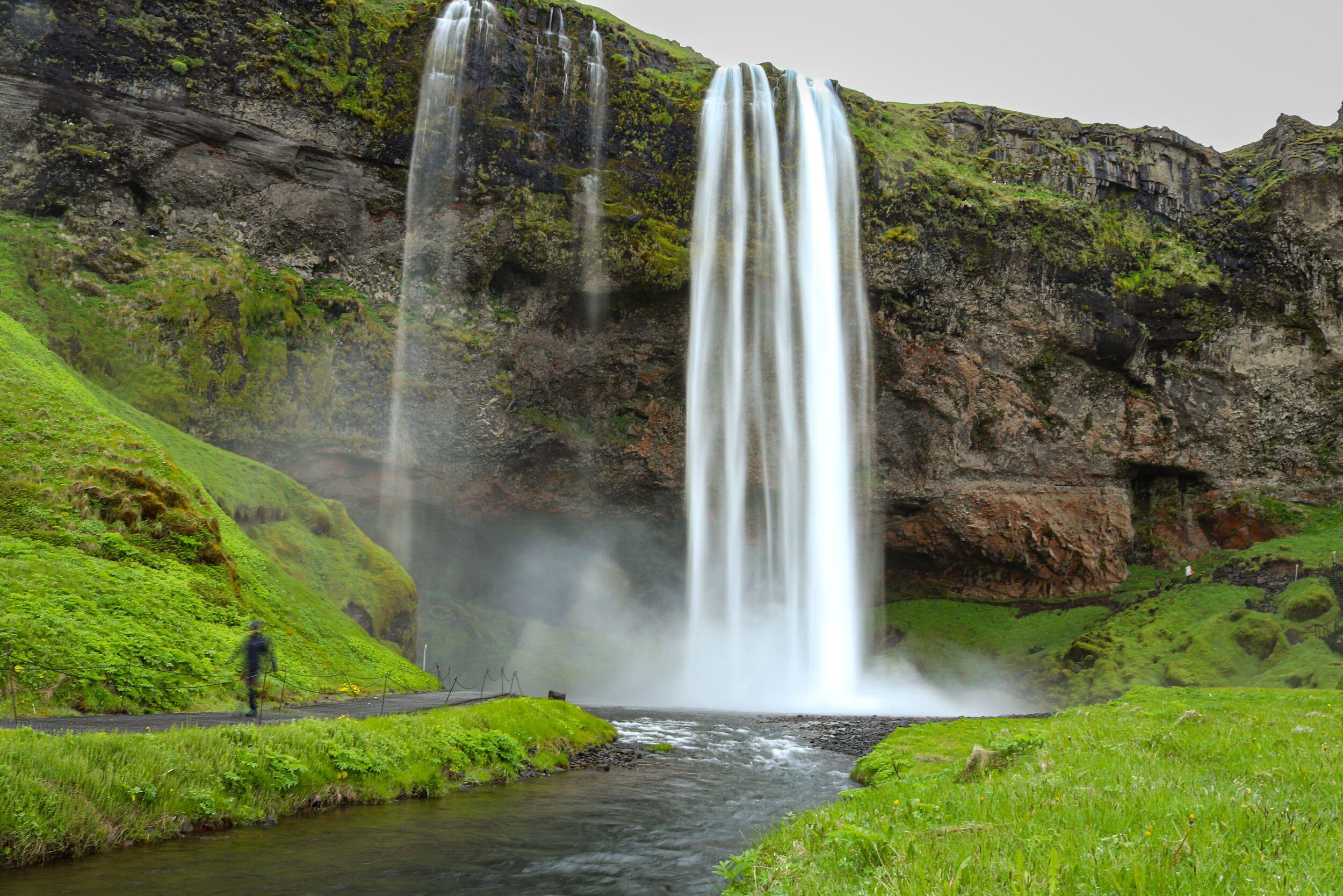 river with a waterfall that is falling into the river