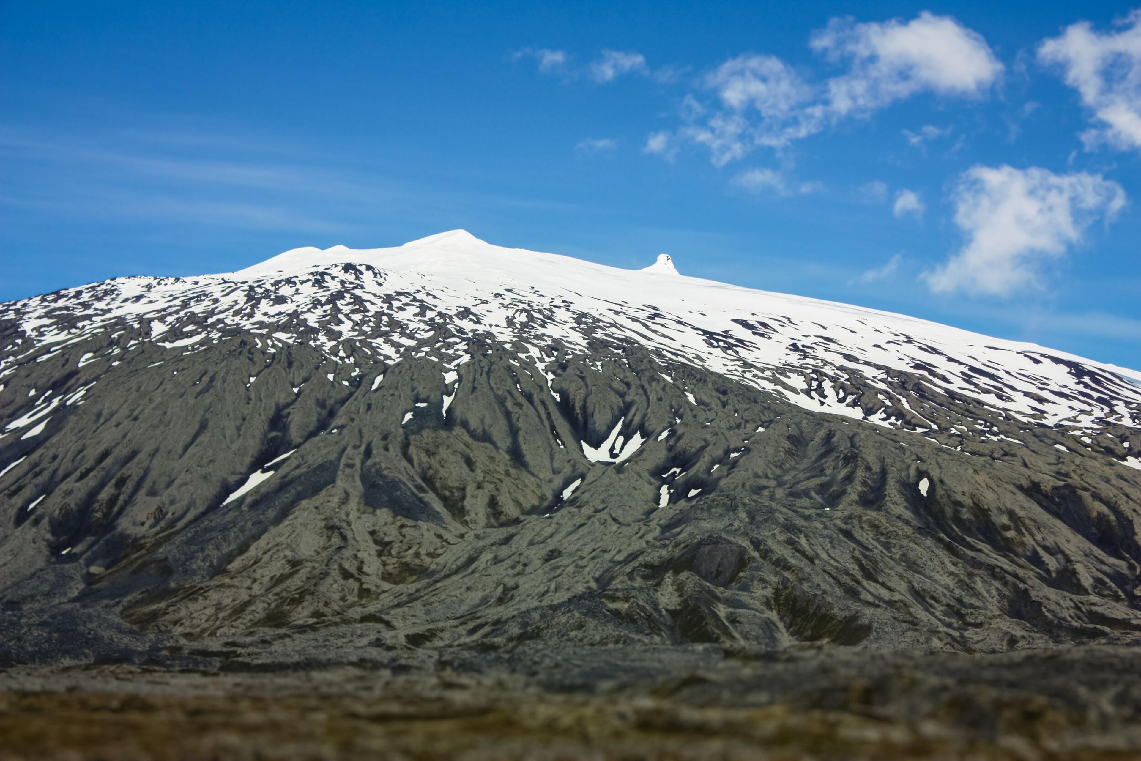 The snow-covered top of Snæfellsjökull glacier and blue skies in the background