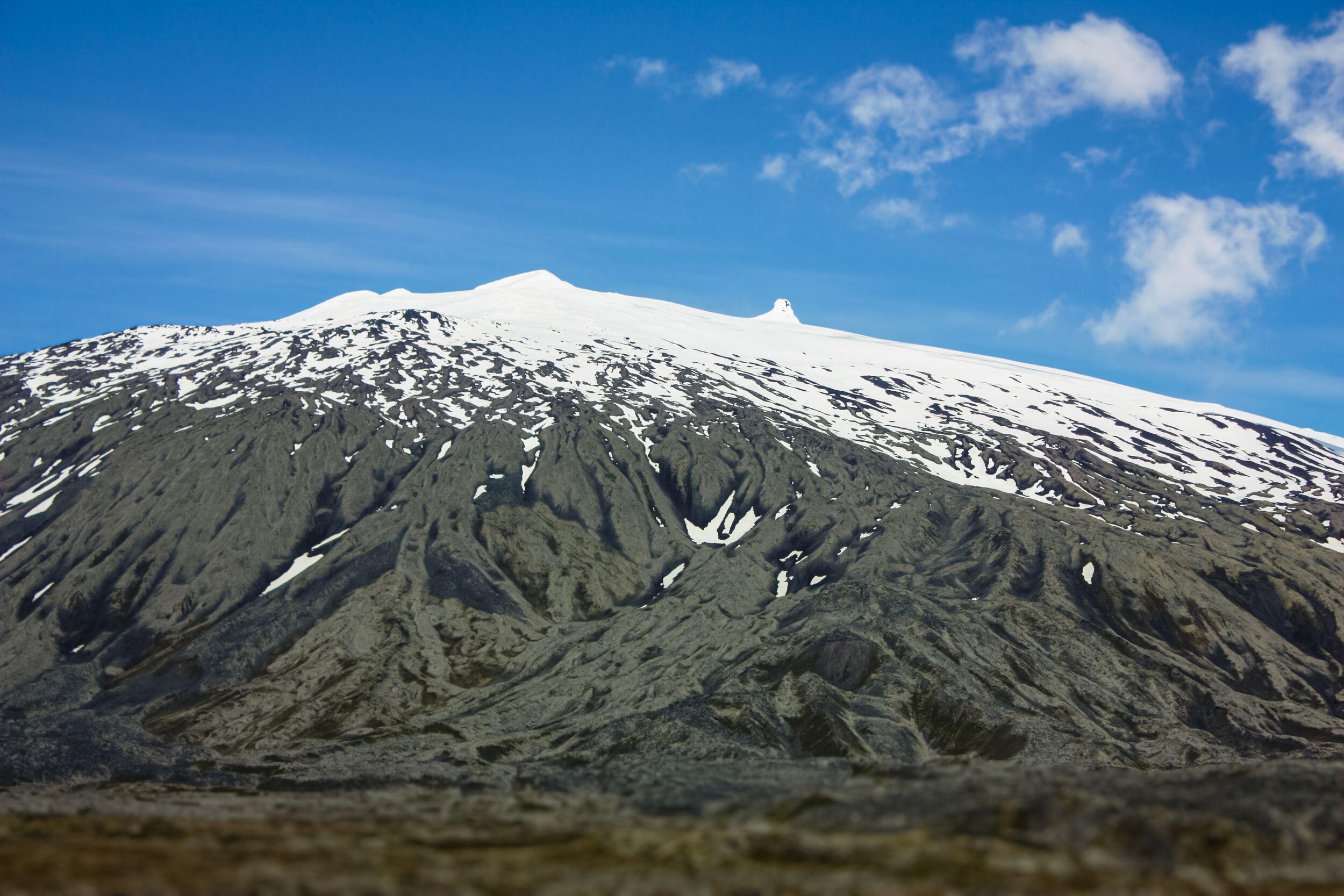 The snow-covered top of Snæfellsjökull glacier and blue skies in the background