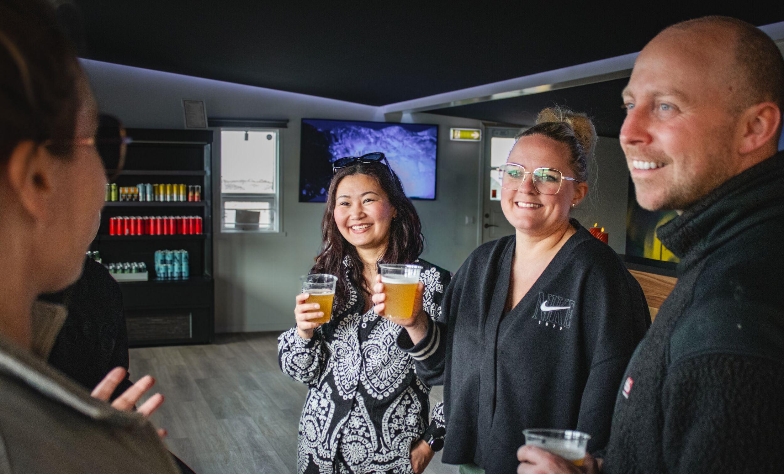 Group of people sharing drinks and socializing.