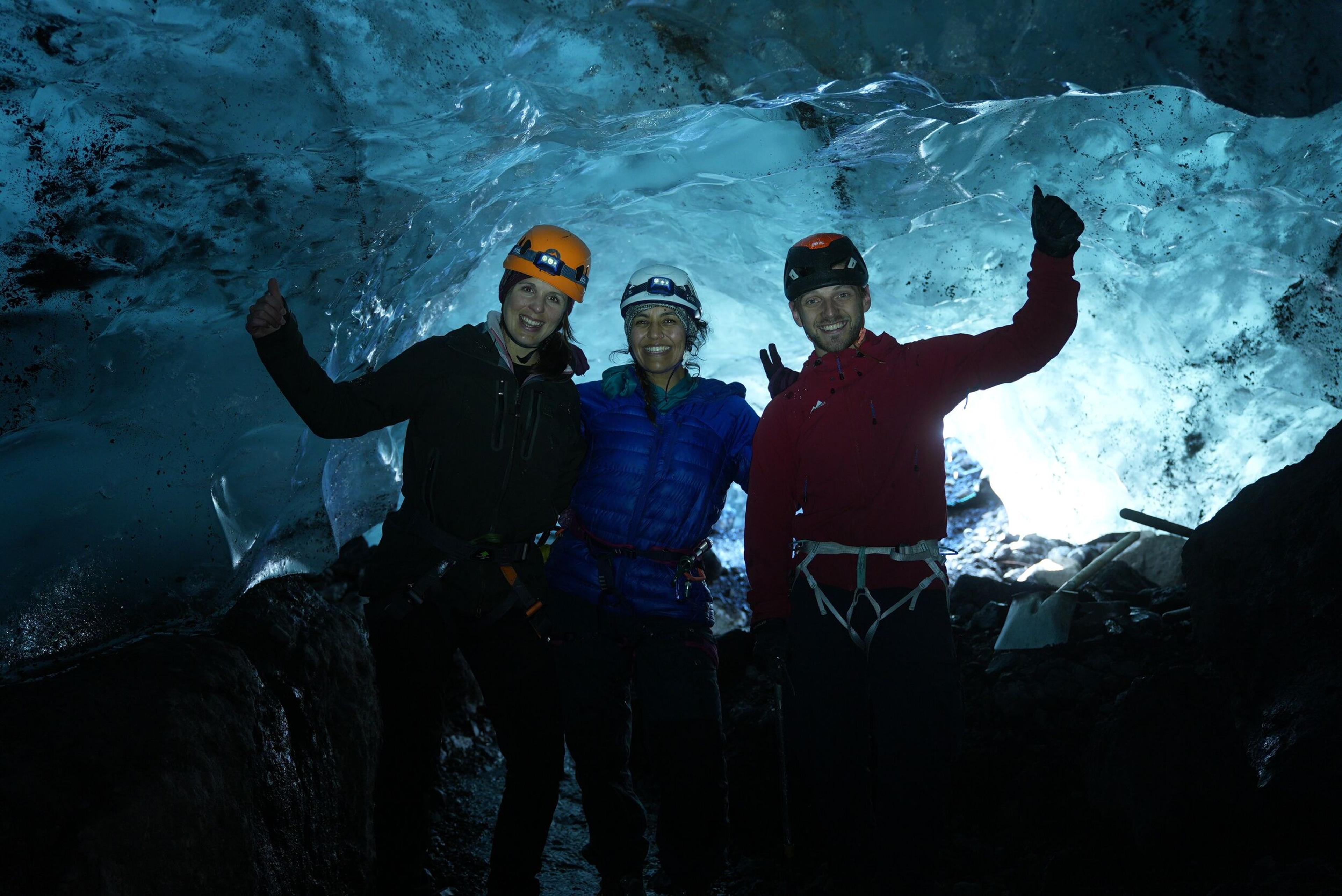 Icelandic Mountain Guide with guests inside an ice cave 