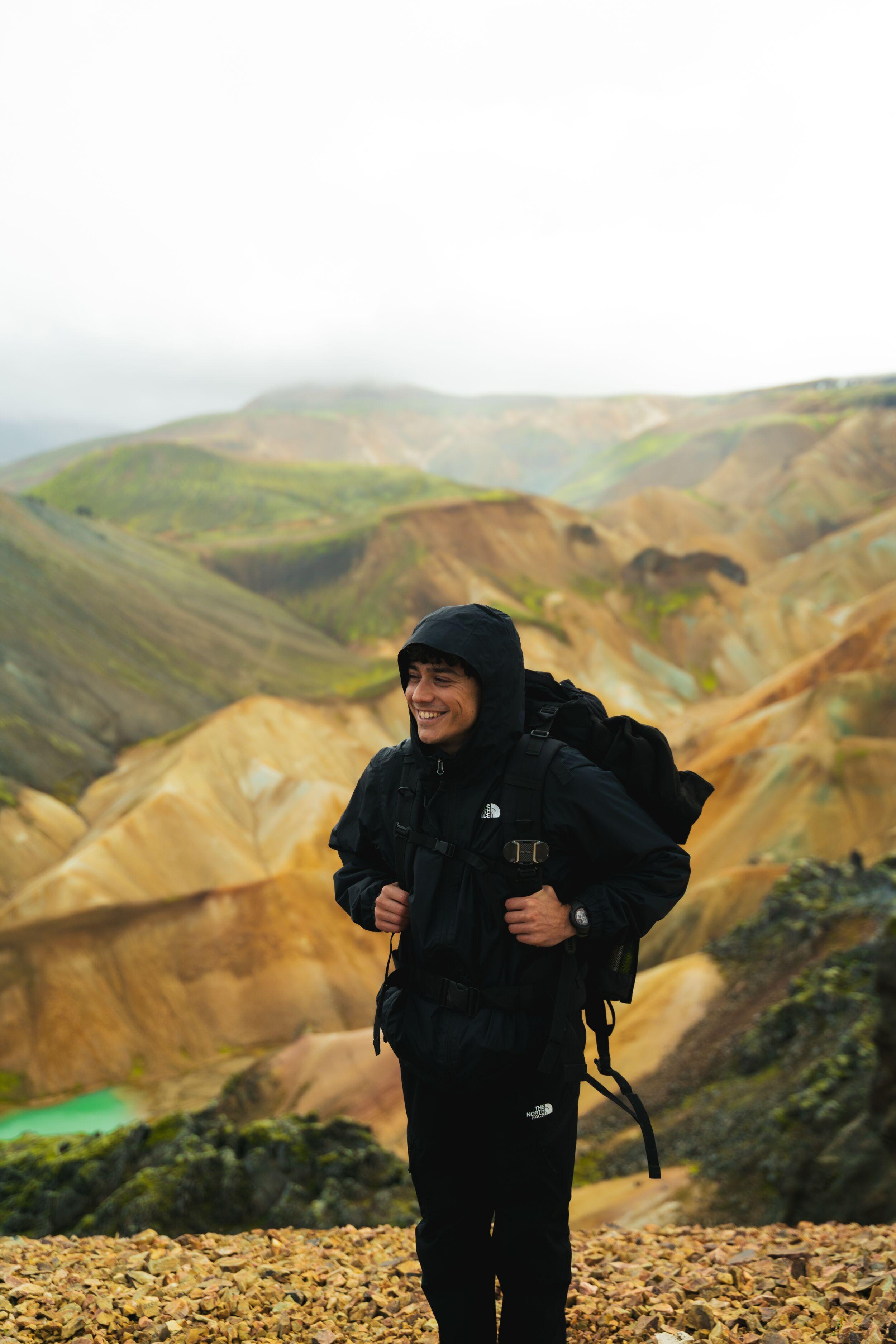 A single hiker at Landmannalaugar in full hiking gear with a backpack