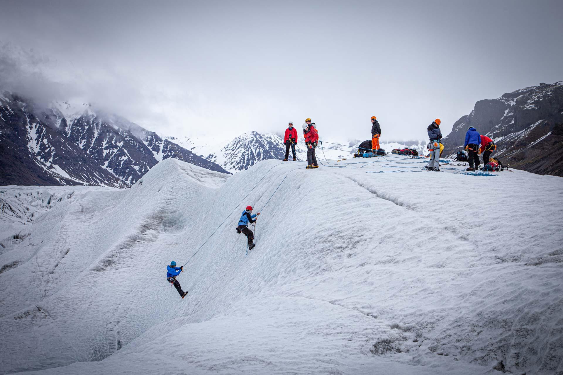 A group snow climbing up a mountain