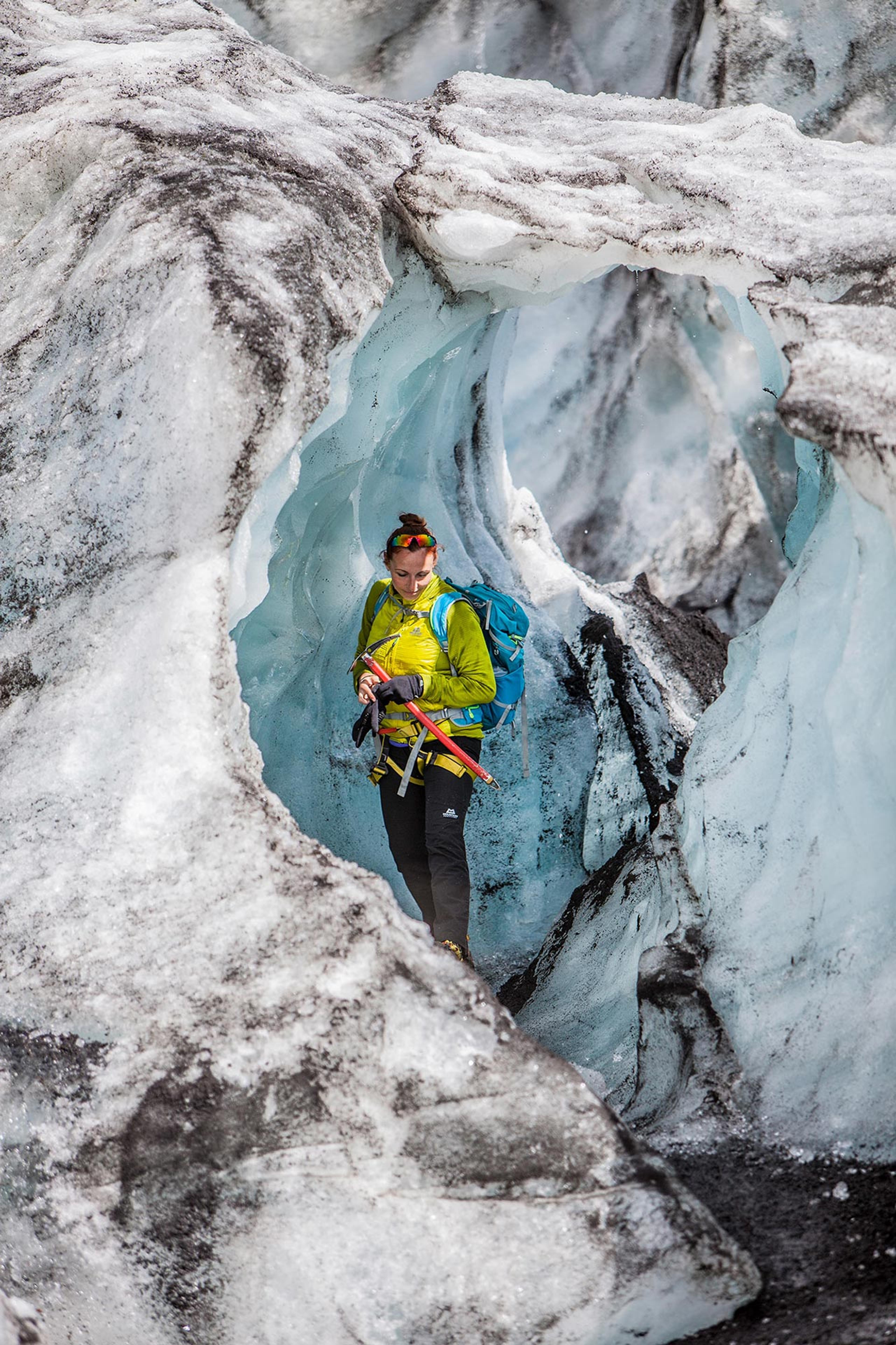 Woman inside beautiful ice formations of a glacier 