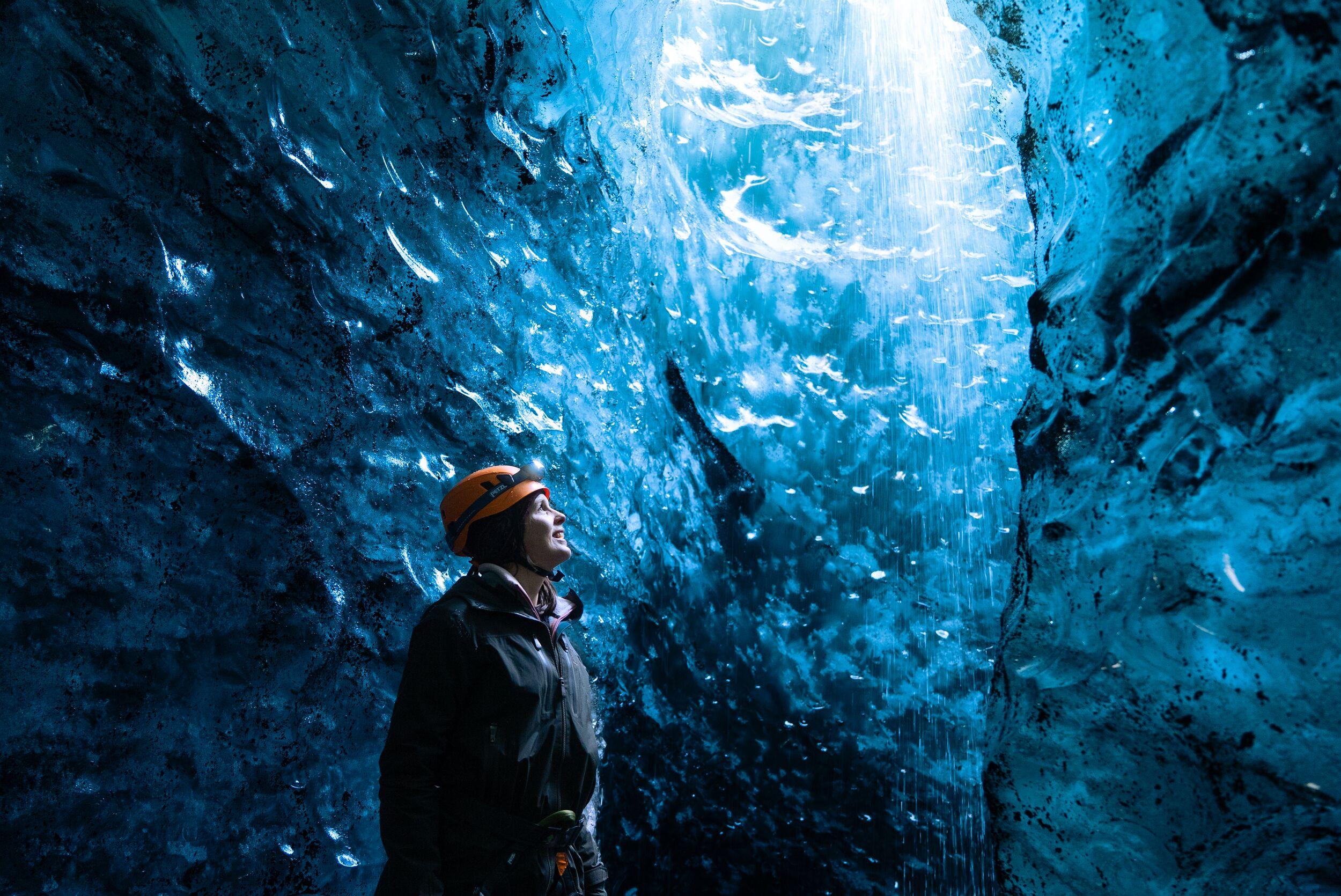 Woman in a Ice Cave with a helment on her head