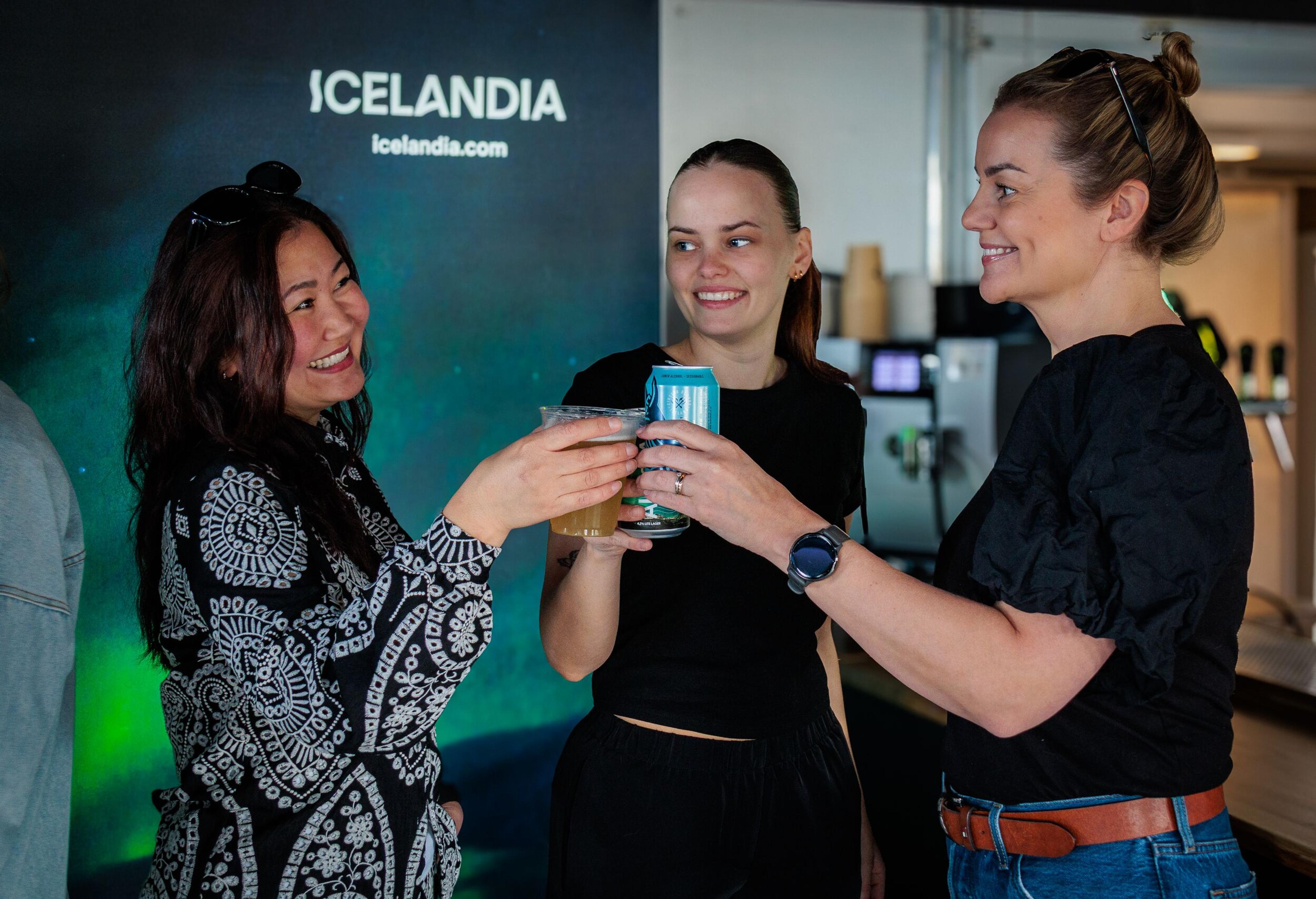 Three women raising their glasses for a toast.