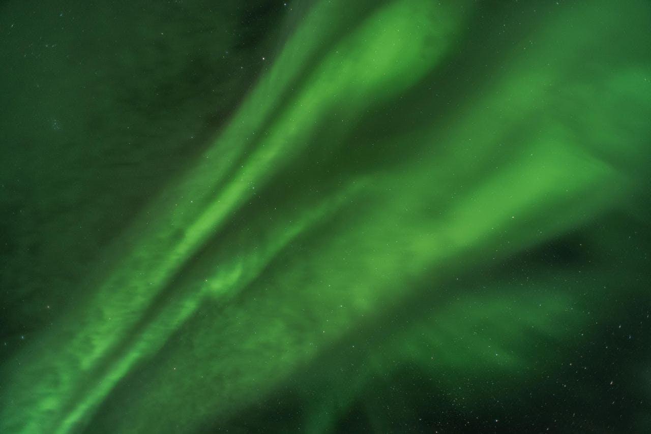The bright greenNorthern Lights in Iceland dancing in the sky
