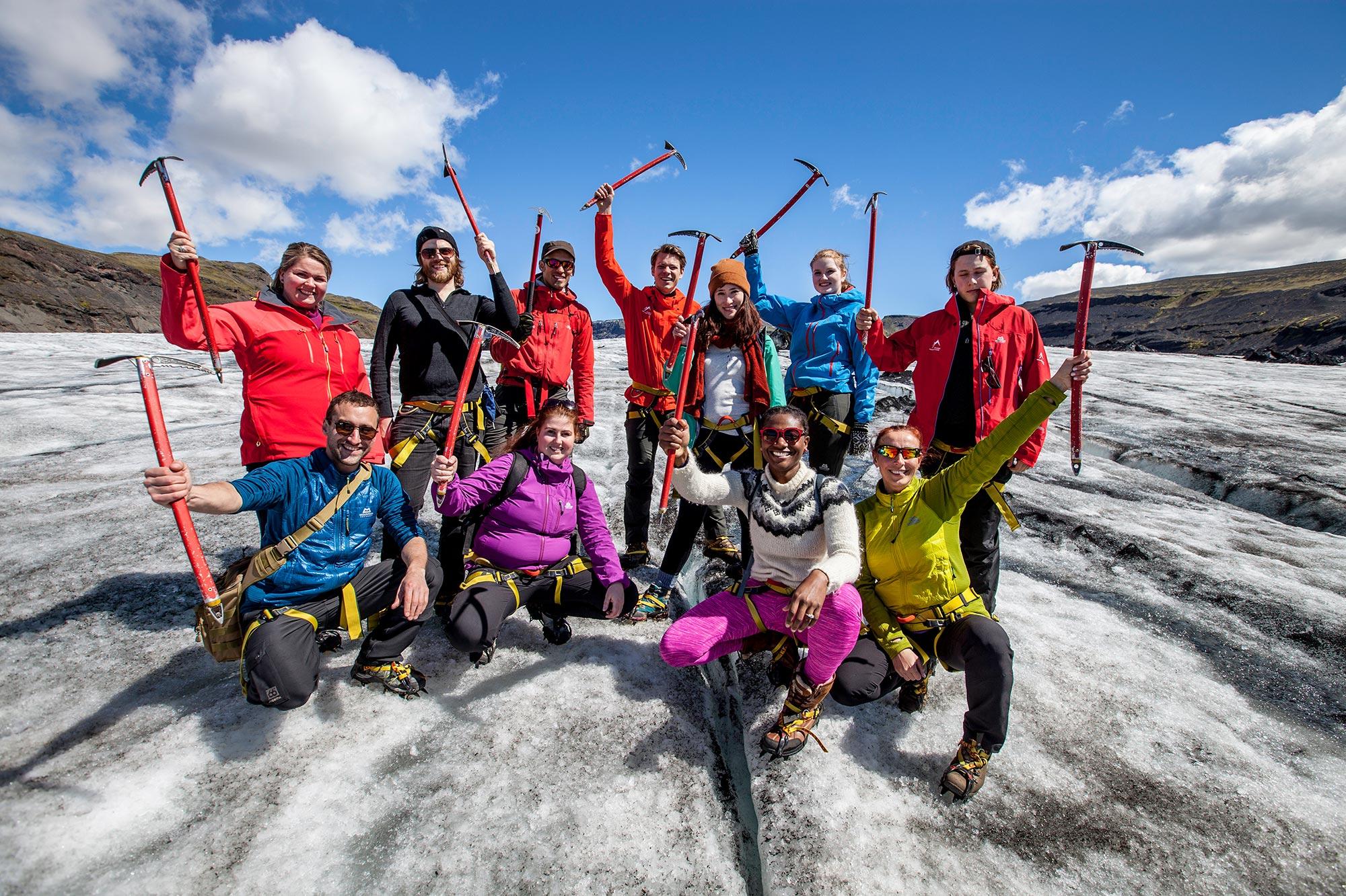 People posing for picture on Sólheimajökull glacier whilst on a glacier walk