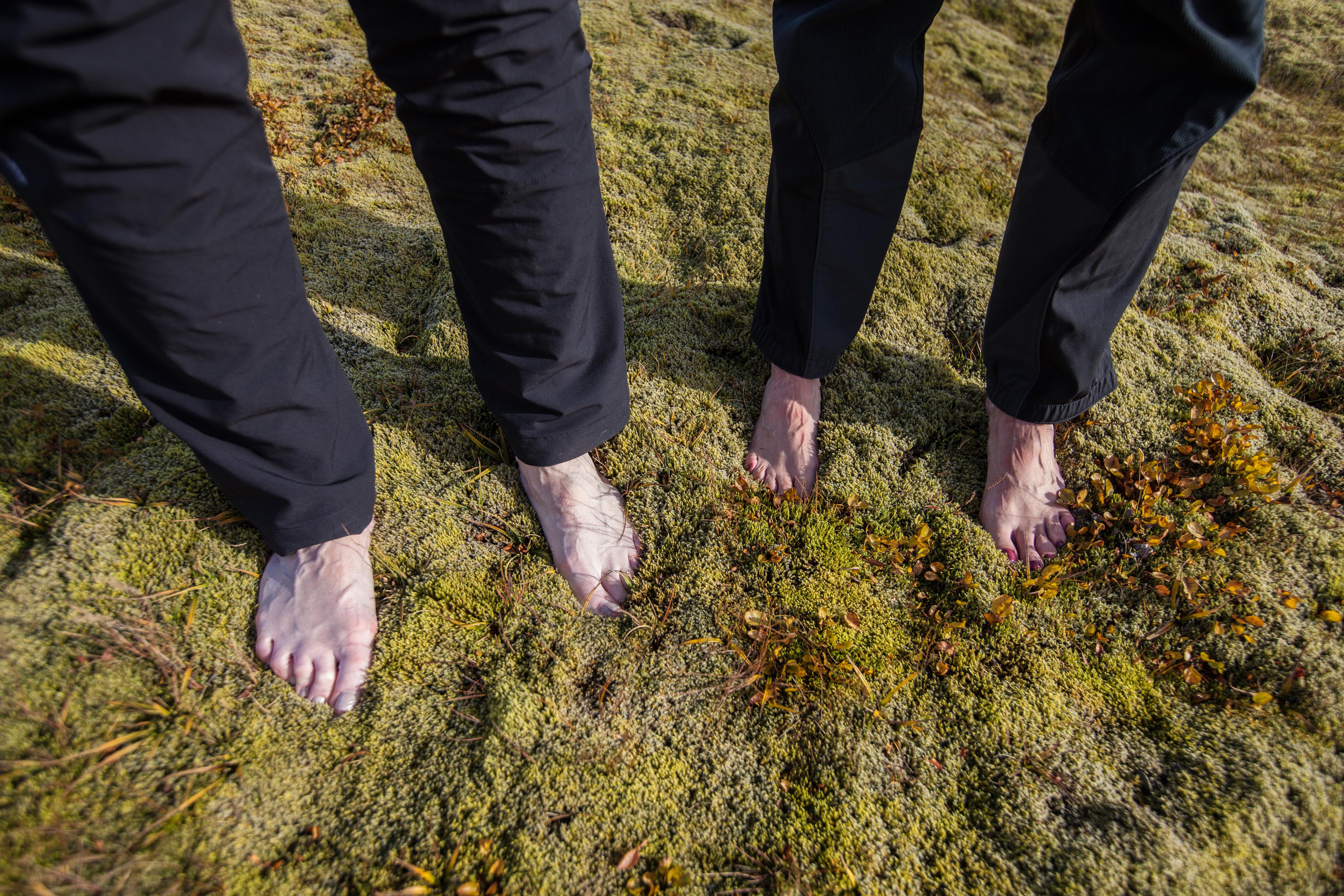 Two women standing in the moss with bare feet