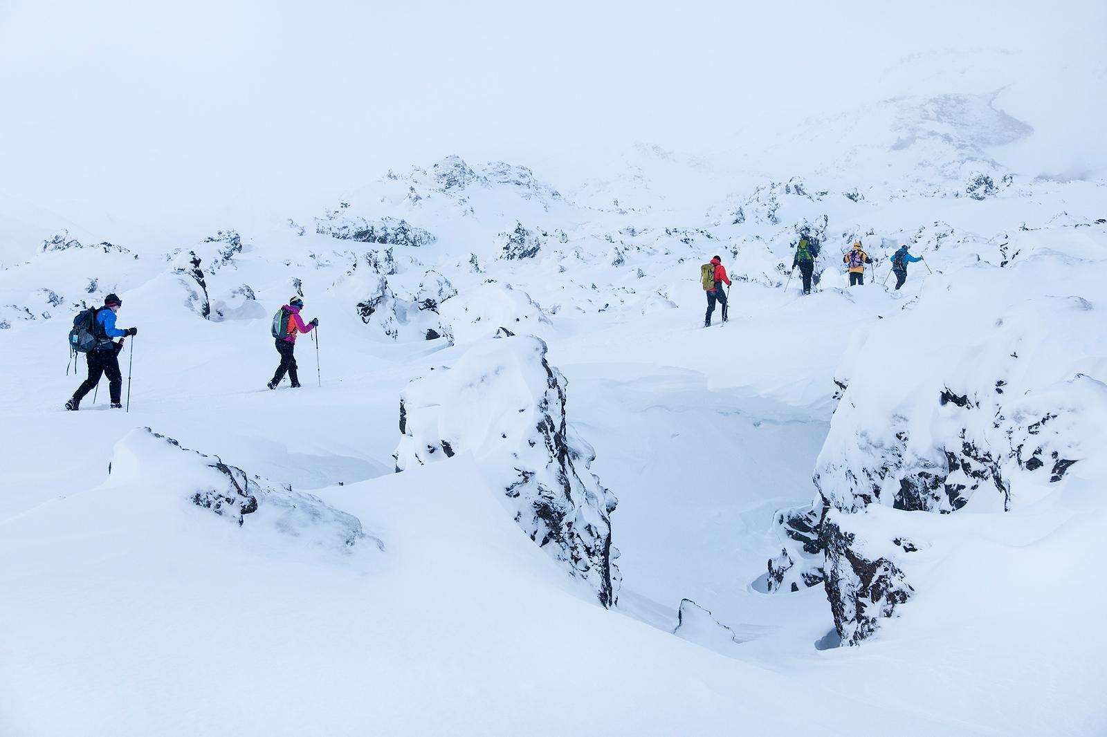 People hiking in snowy rocking in Landmannalaugar