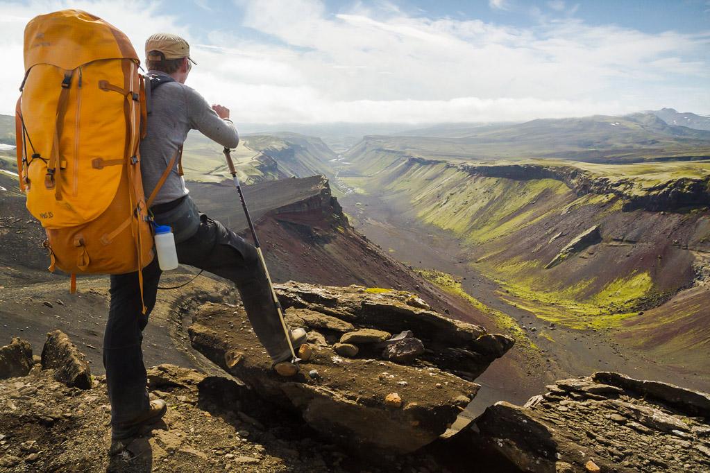 A hiker admiring the view from the top of a mountain