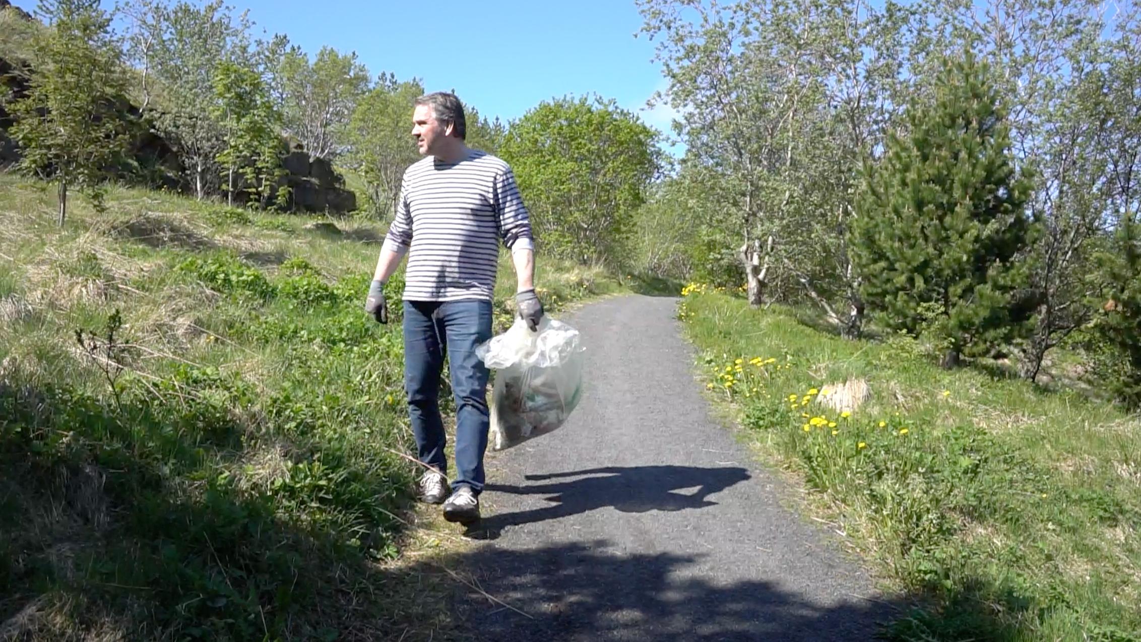 Man disposing of trash in Iceland