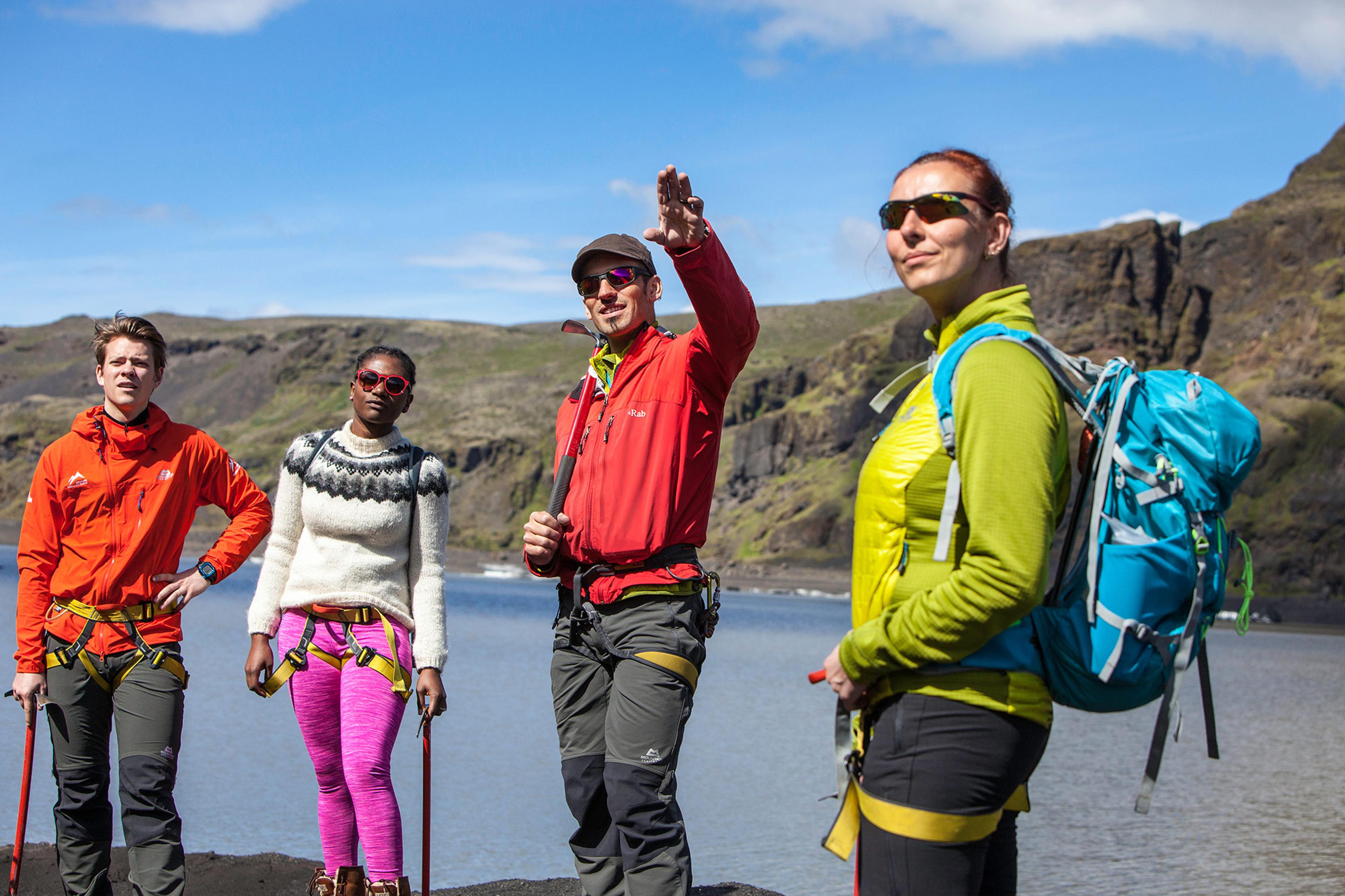 An icelandic mountain guide pointing out something to his group