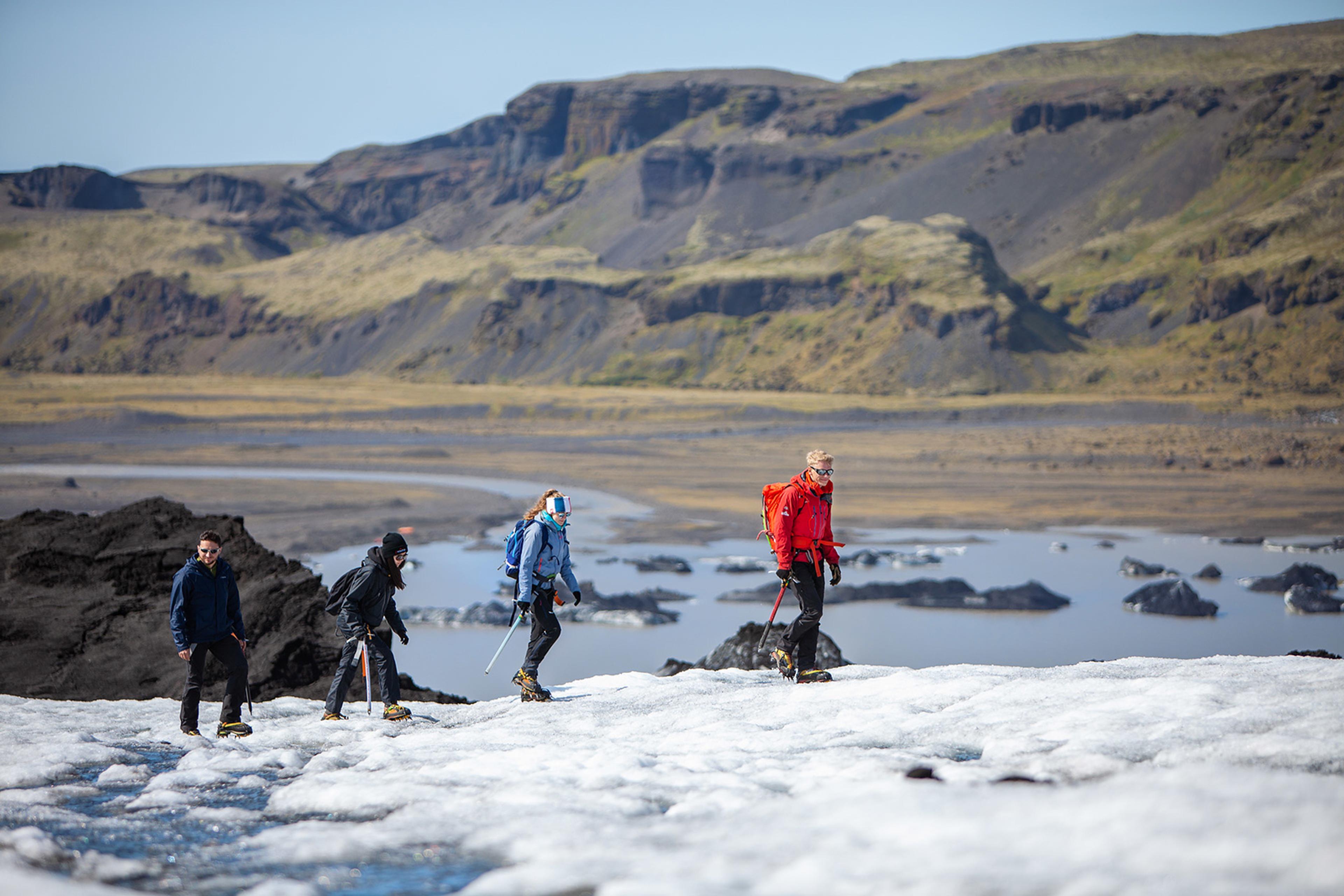 Group of people walking on Solheimajokull glacier