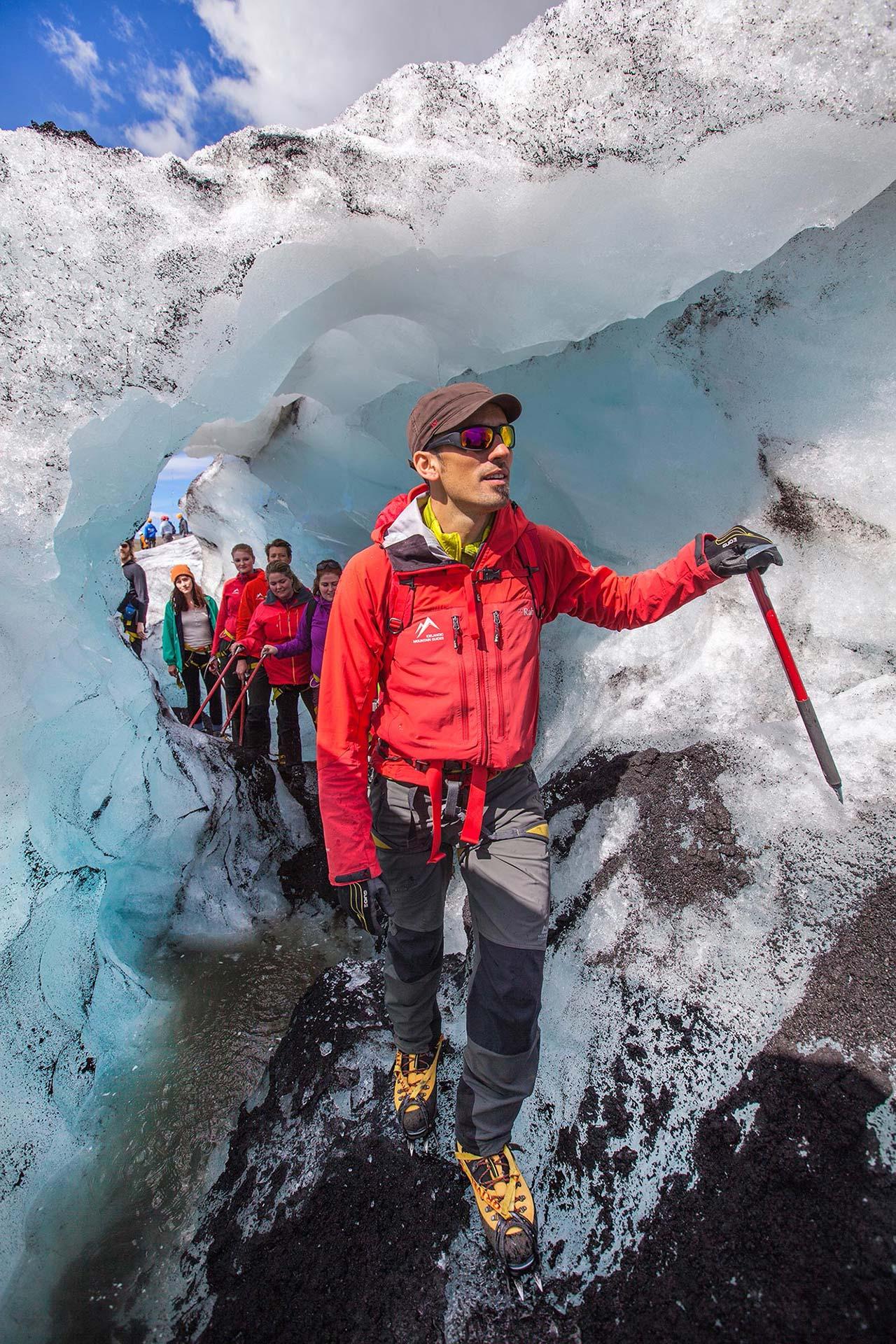 An icelandic mountain guide leading the way through the labyrinth of a glacier tongue