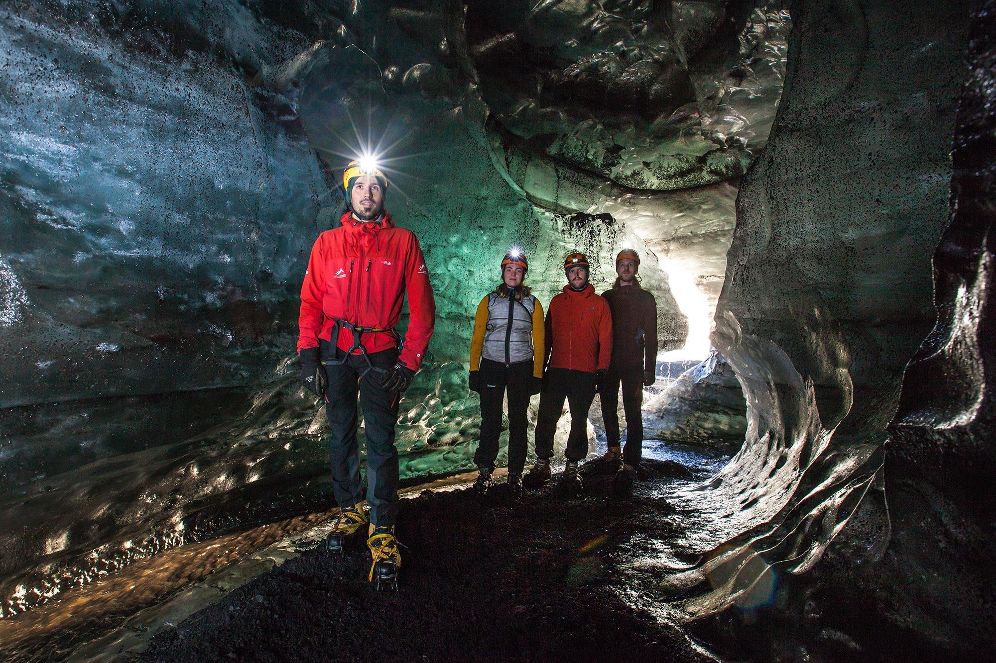 Inside the Secret Ice Cave the Icelandic mountain guide leads the way