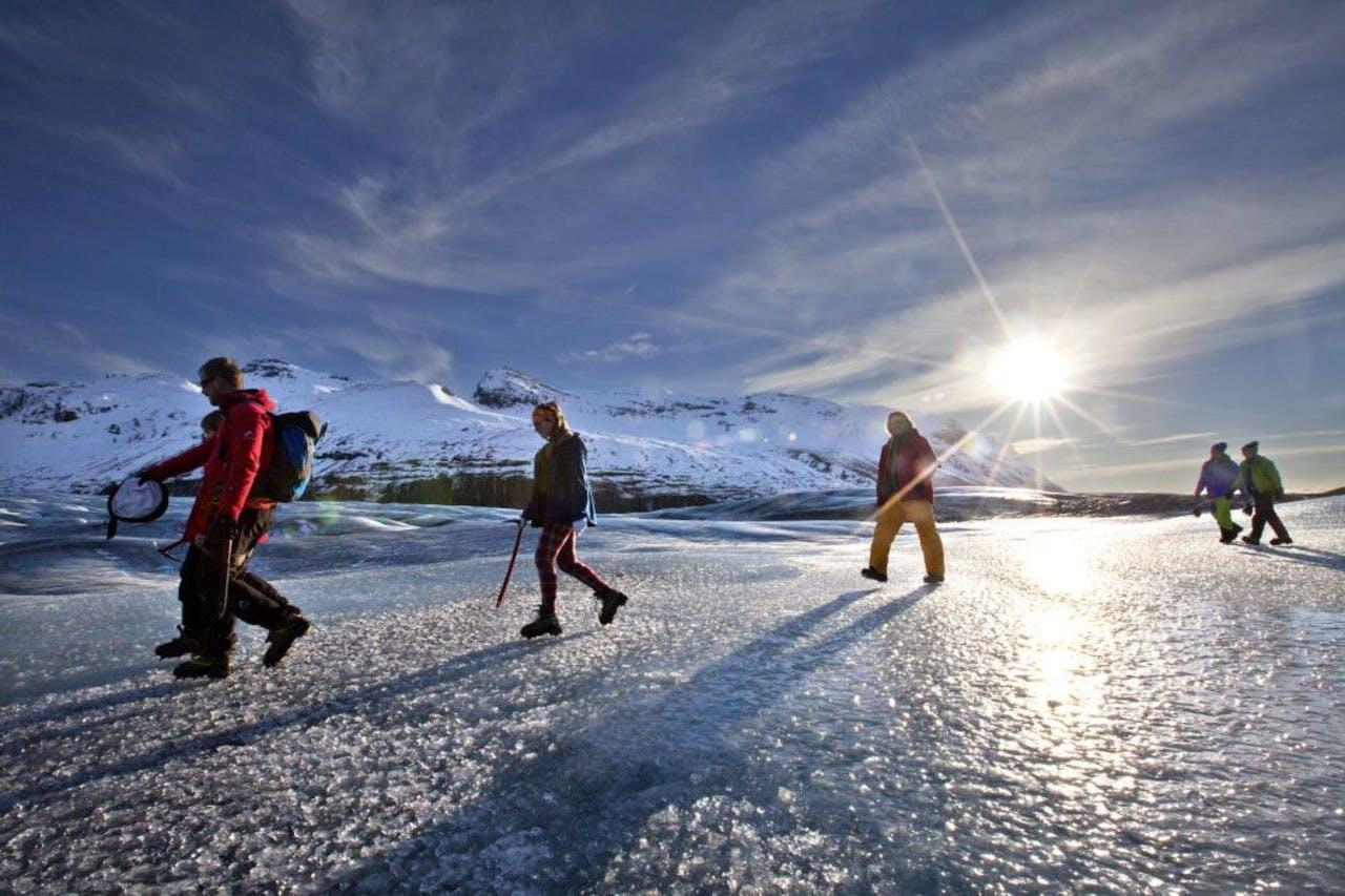 people hiking on a glacier