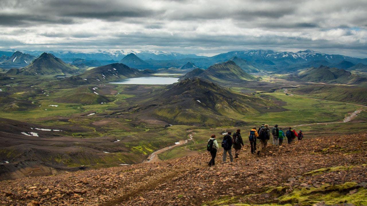 People trekking in Laugavegur, surrounded by beautiful and colorful mountains