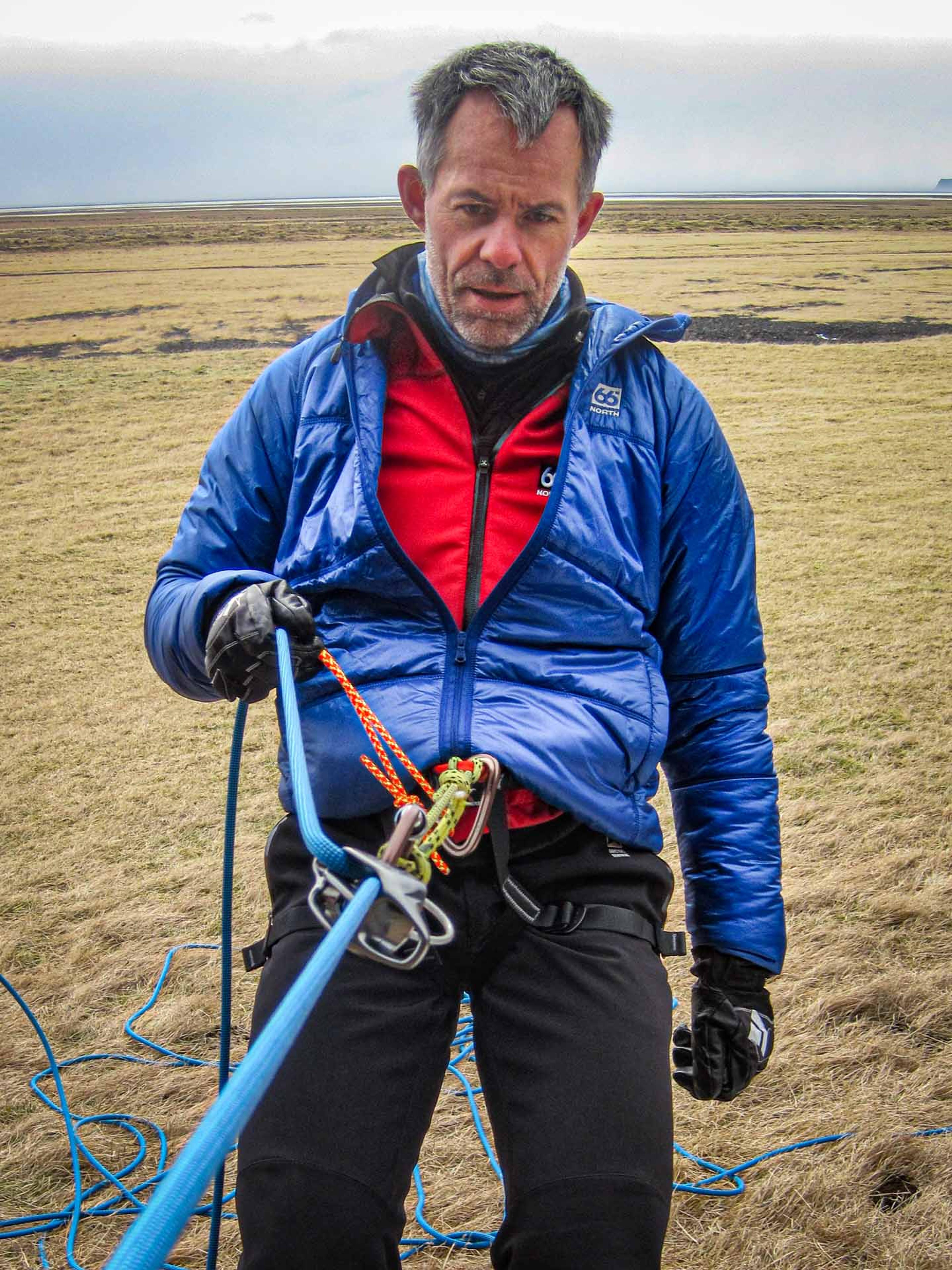 man strapped to climbing gear