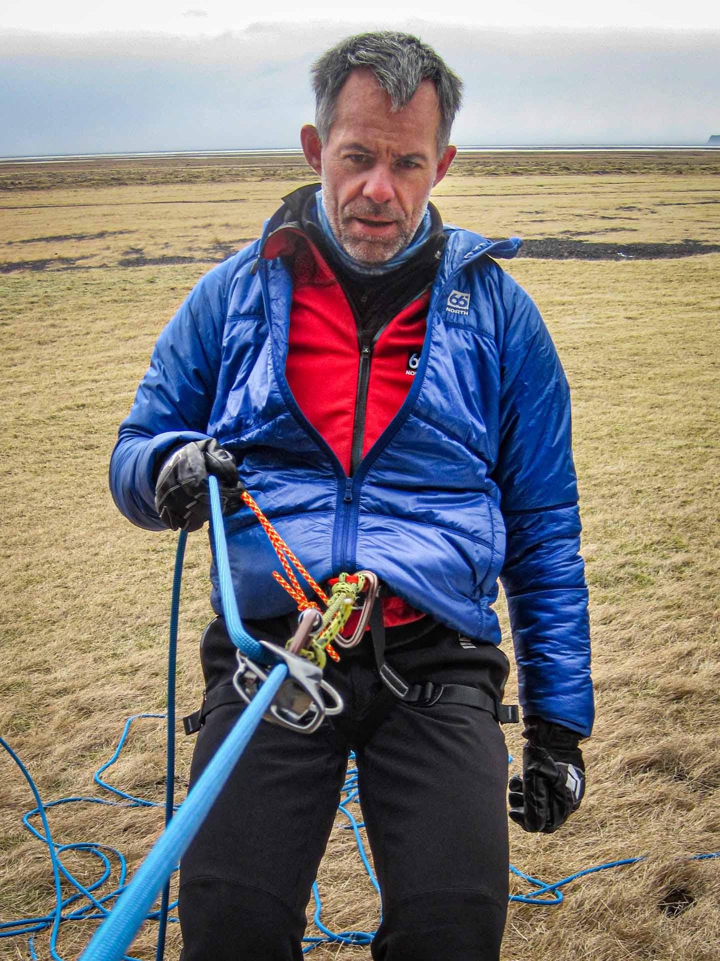man strapped to climbing gear