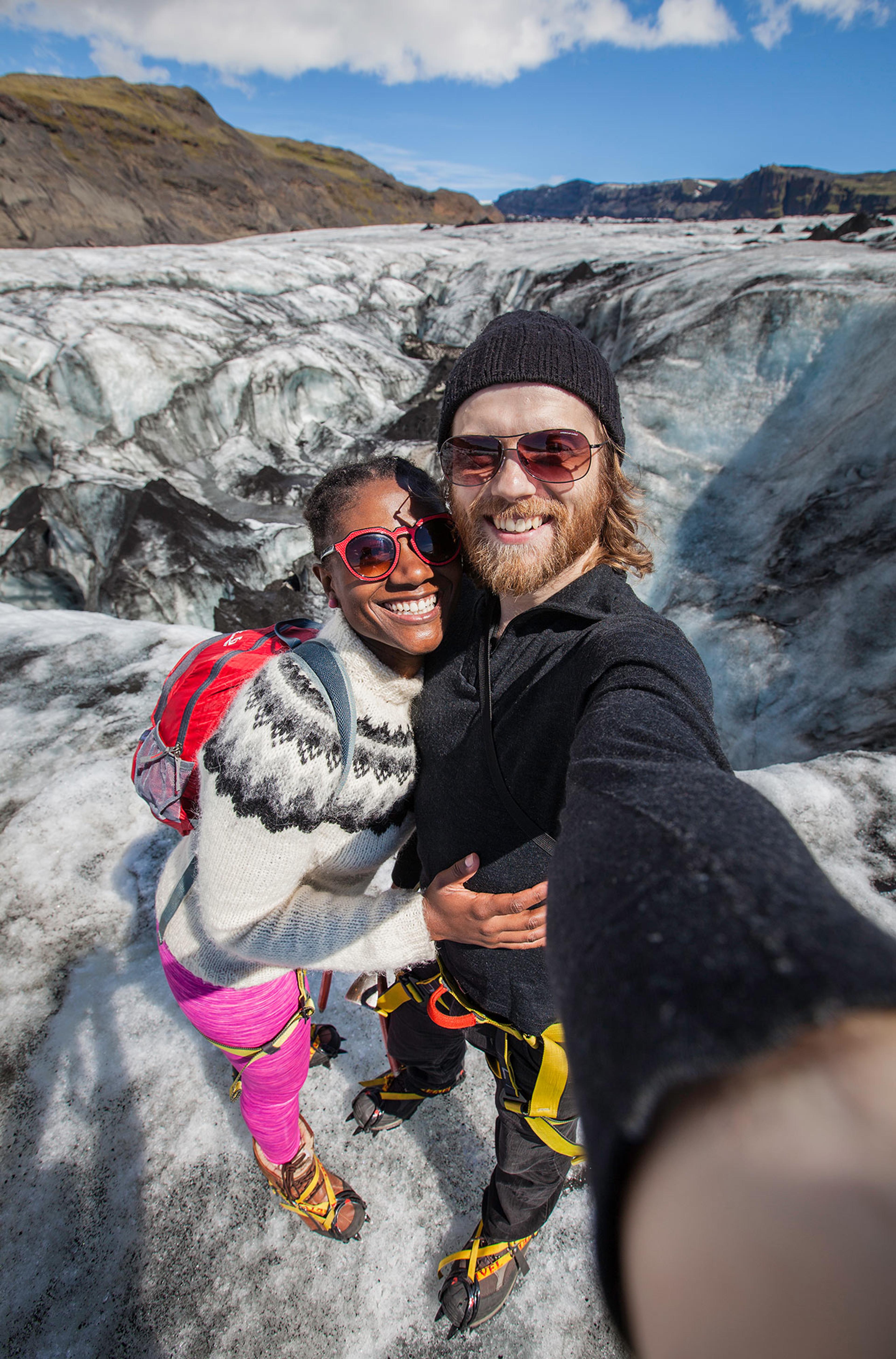 Couple taking selfie on a glacier walk on Sólheimajökull