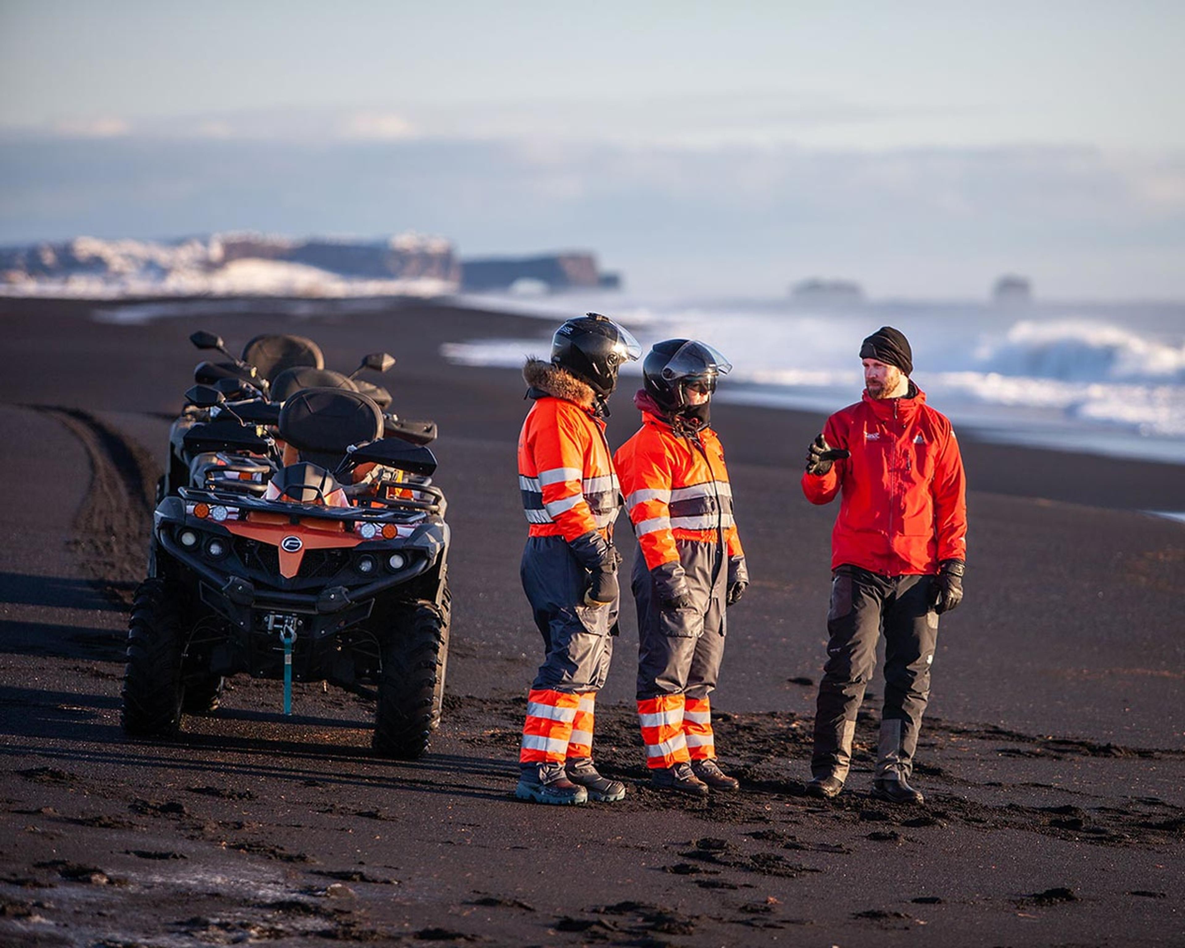 The guide telling people about nature as they stand on the black sand beach