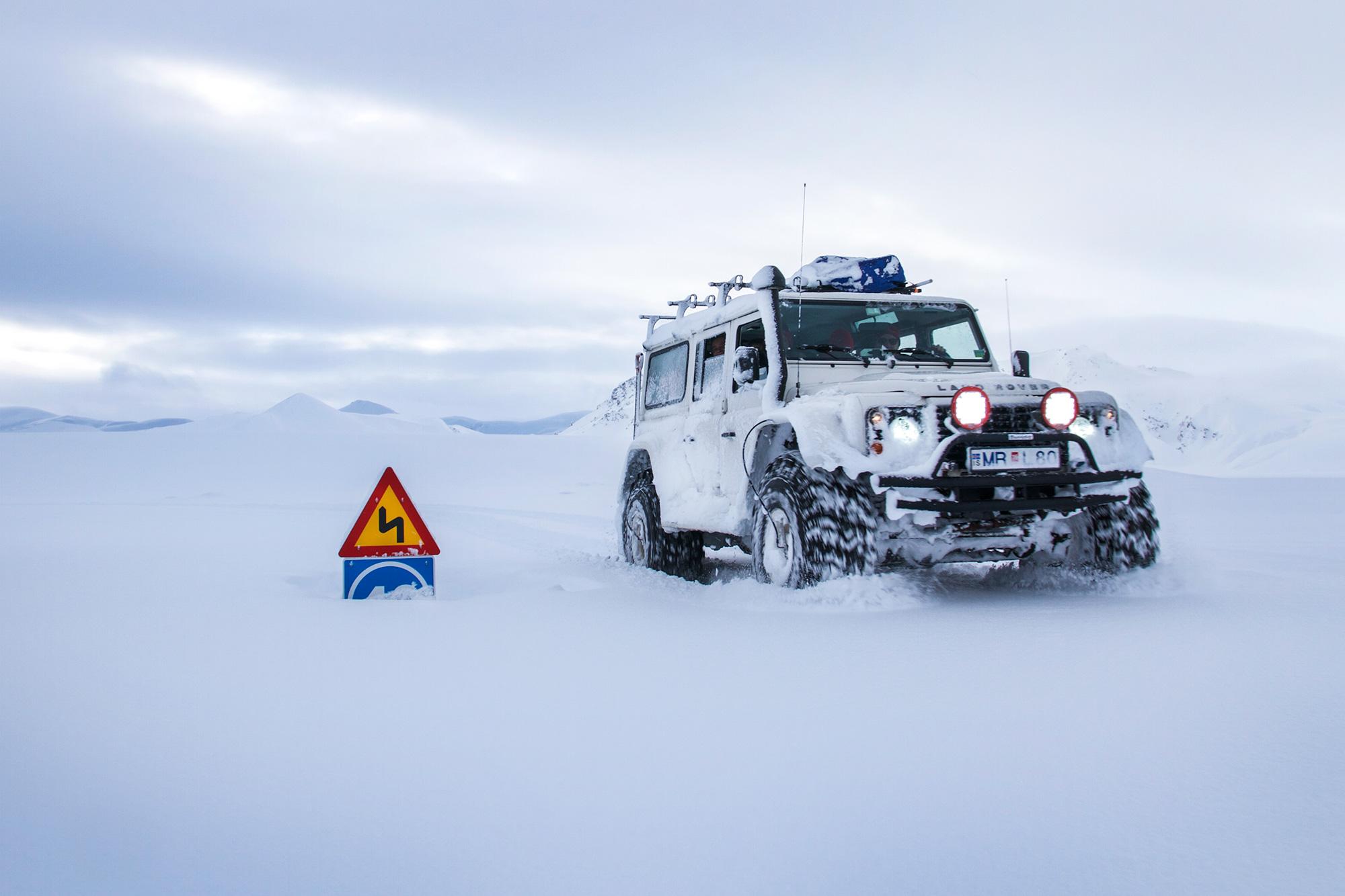 a white land rover car in the snowy nature