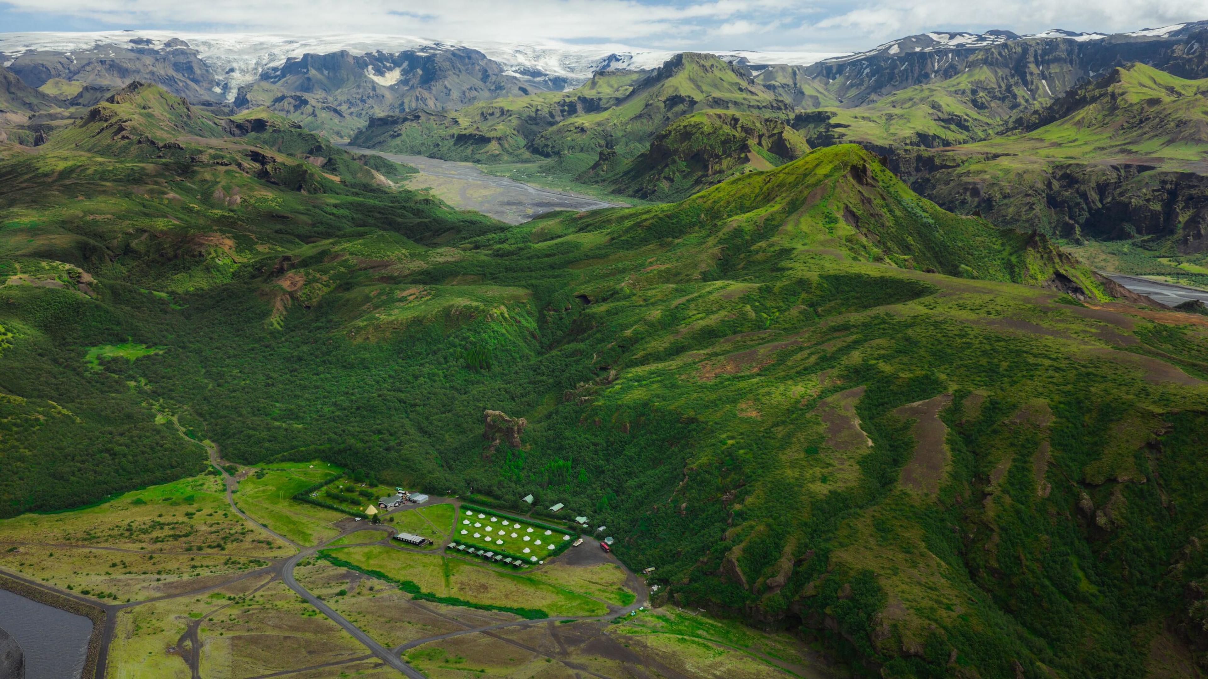 Aerial view of the green highland oasis of Þórsmörk with glaciers and mountains in the background