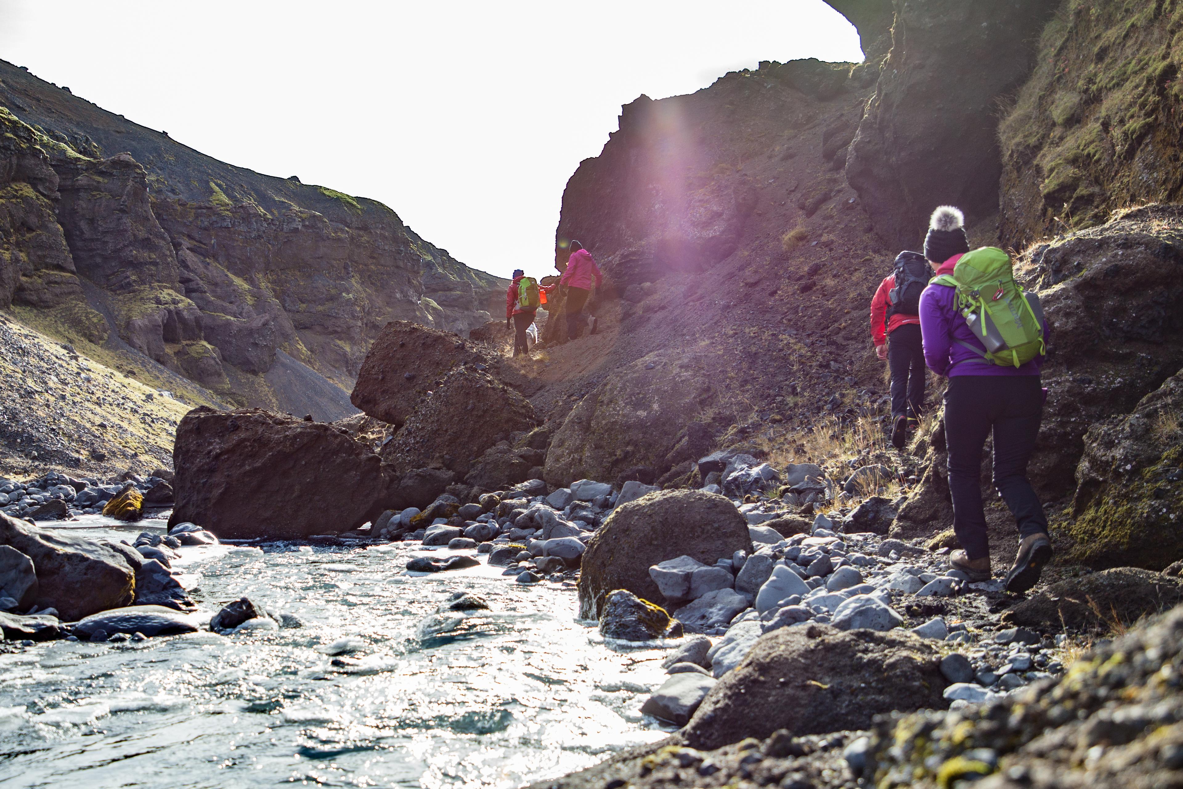 The group walking close to the river that runs in the bottom of the valley