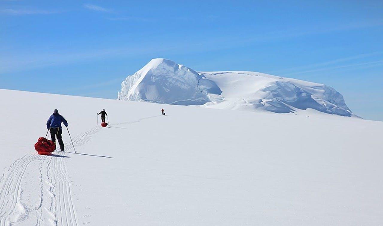 Three mountaineers crossing a snowy hill on Vatnajökull glacier on a tour with Icelandic Mountain Guides