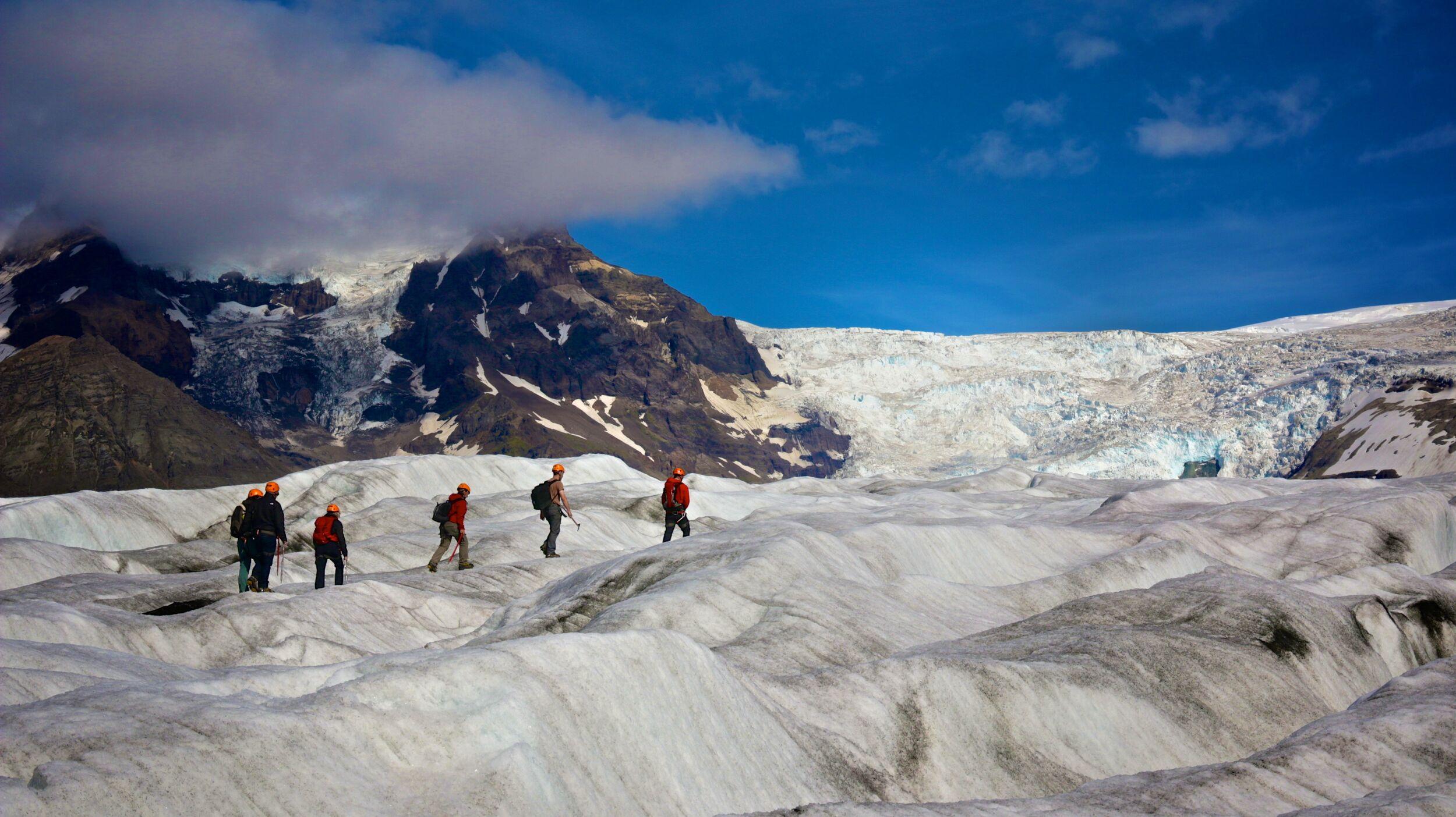 people walking on a glacier