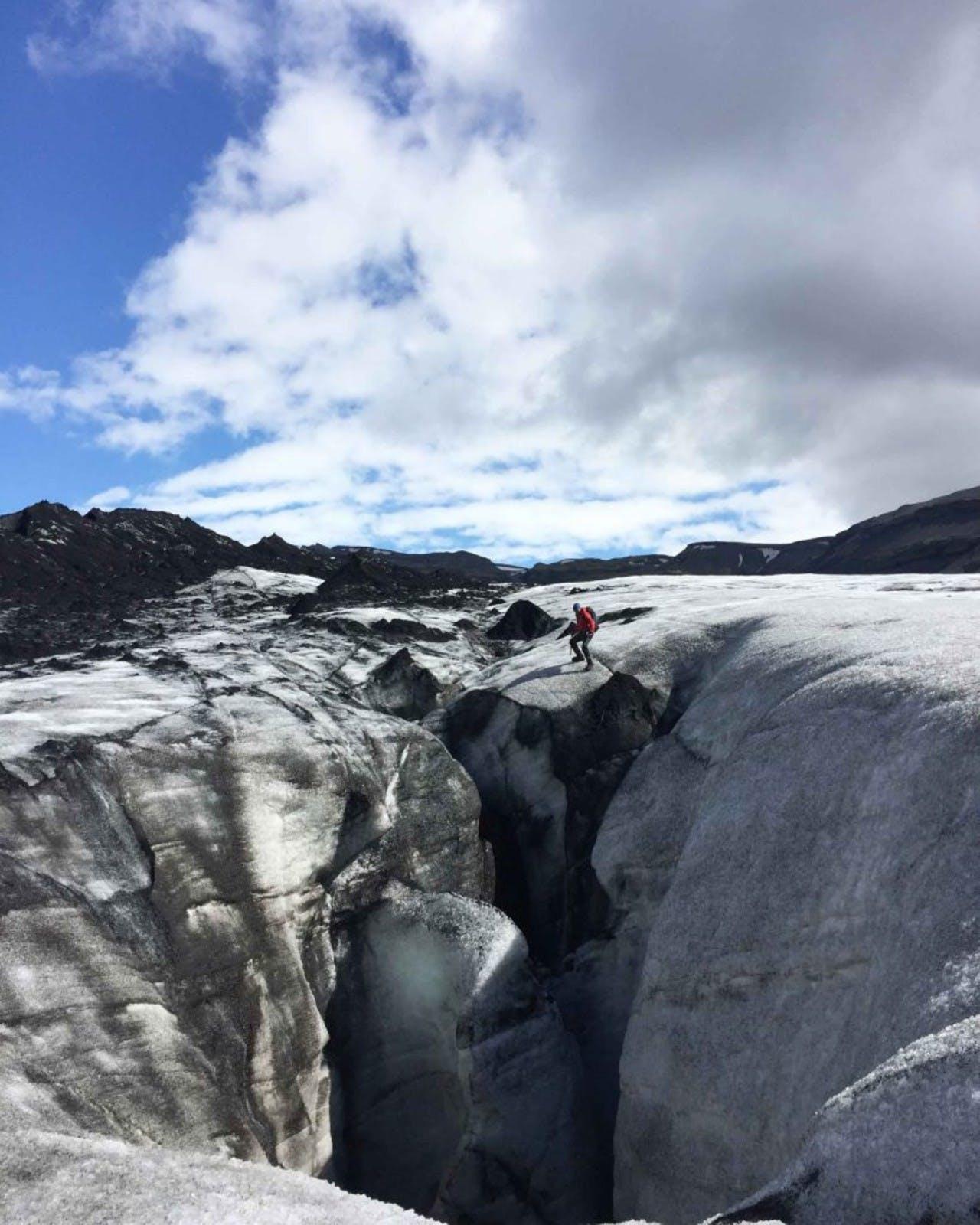 A man standing above a glacier