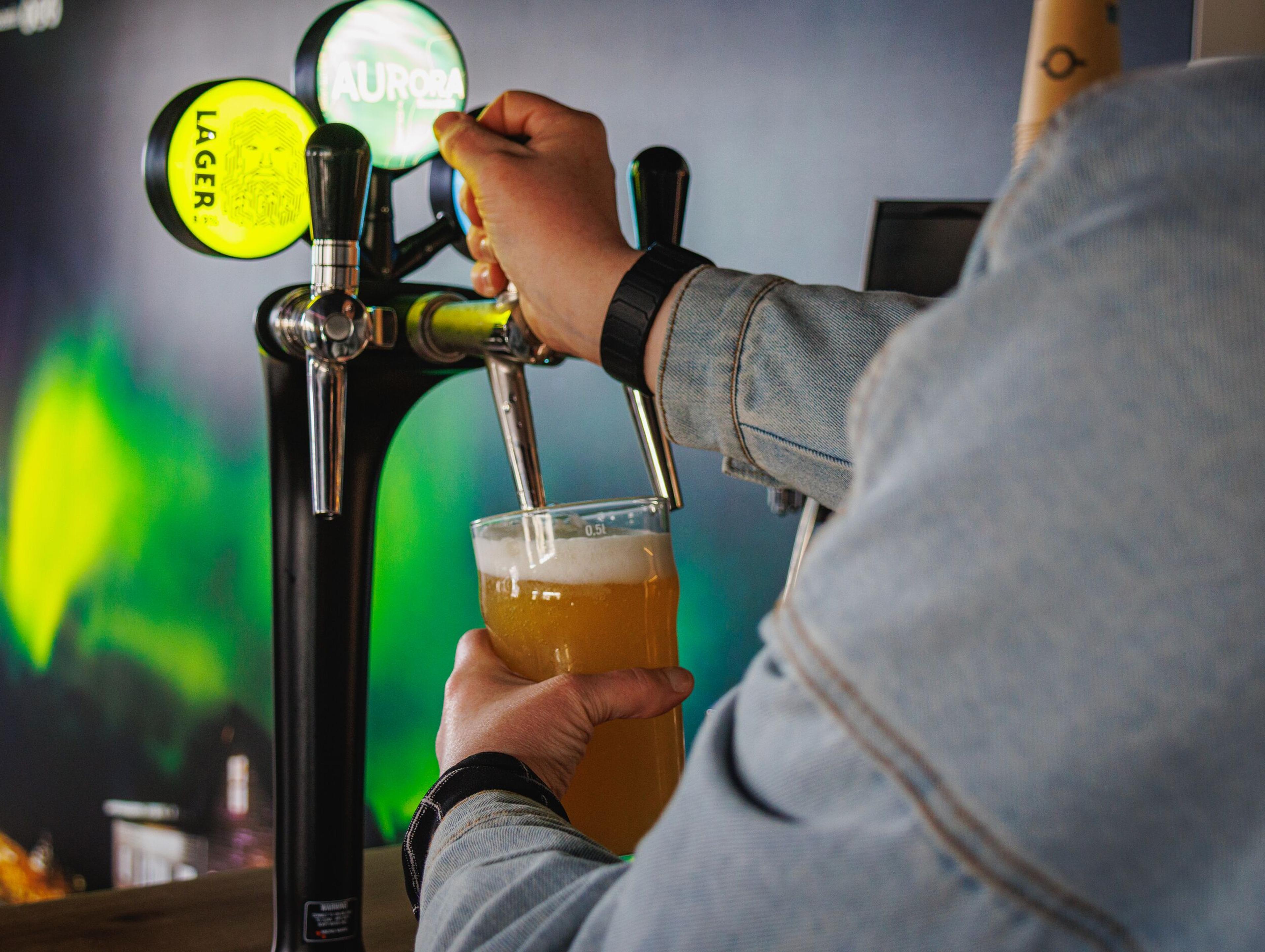 Beer being poured from a tap into a glass.